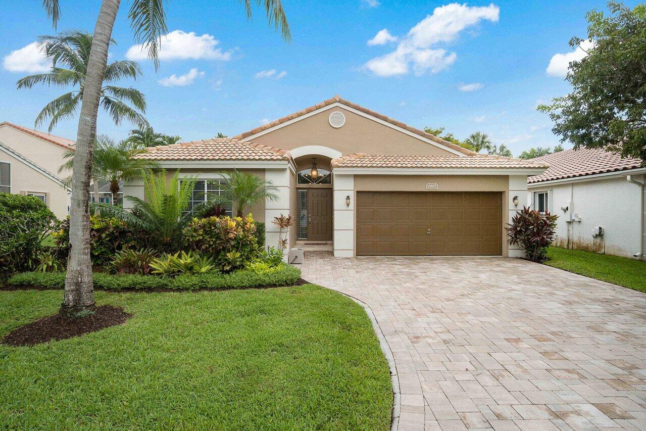 Welcome to The Harbors at Riverglen! This beautifully maintained lakefront residence offers 3 bedrooms, 2 bathrooms, and a desirable split-bedroom floor plan designed for both comfort and privacy. Soaring vaulted ceilings and abundant natural light create an open, airy feel throughout the home. The updated kitchen features white shaker-style cabinetry, granite countertops, stainless steel appliances, and ample storage. Elegant marble flooring flows through the main living areas, while luxury vinyl flooring adds warmth to the bedrooms. Updated bathrooms, laundry room, and custom closet systems throughout. Impact-rated windows and doors, a barrel tile roof replaced in 2018, a TRANE AC installed in 2023, and a water heater replaced in 2022.  Step outside to your private backyard retreat featuring tranquil lake views, a covered patio, an expansive travertine deck, and a fully fenced yard—perfect for entertaining, pets, or simply enjoying the South Florida lifestyle.  The air-conditioned two-car garage has been finished to provide approximately 420 square feet of flexible bonus space, ideal for a home office, gym, media room, or playroom, with the option to convert it back to a traditional garage.  Residents of The Harbors at Riverglen enjoy resort-style amenities including a community pool, clubhouse, fitness center, tennis and pickleball courts, and playground. HOA dues include lawn maintenance and irrigation. Conveniently located near I-95, Florida's Turnpike, Sawgrass Expressway, shopping, dining, and Quiet Waters Park.