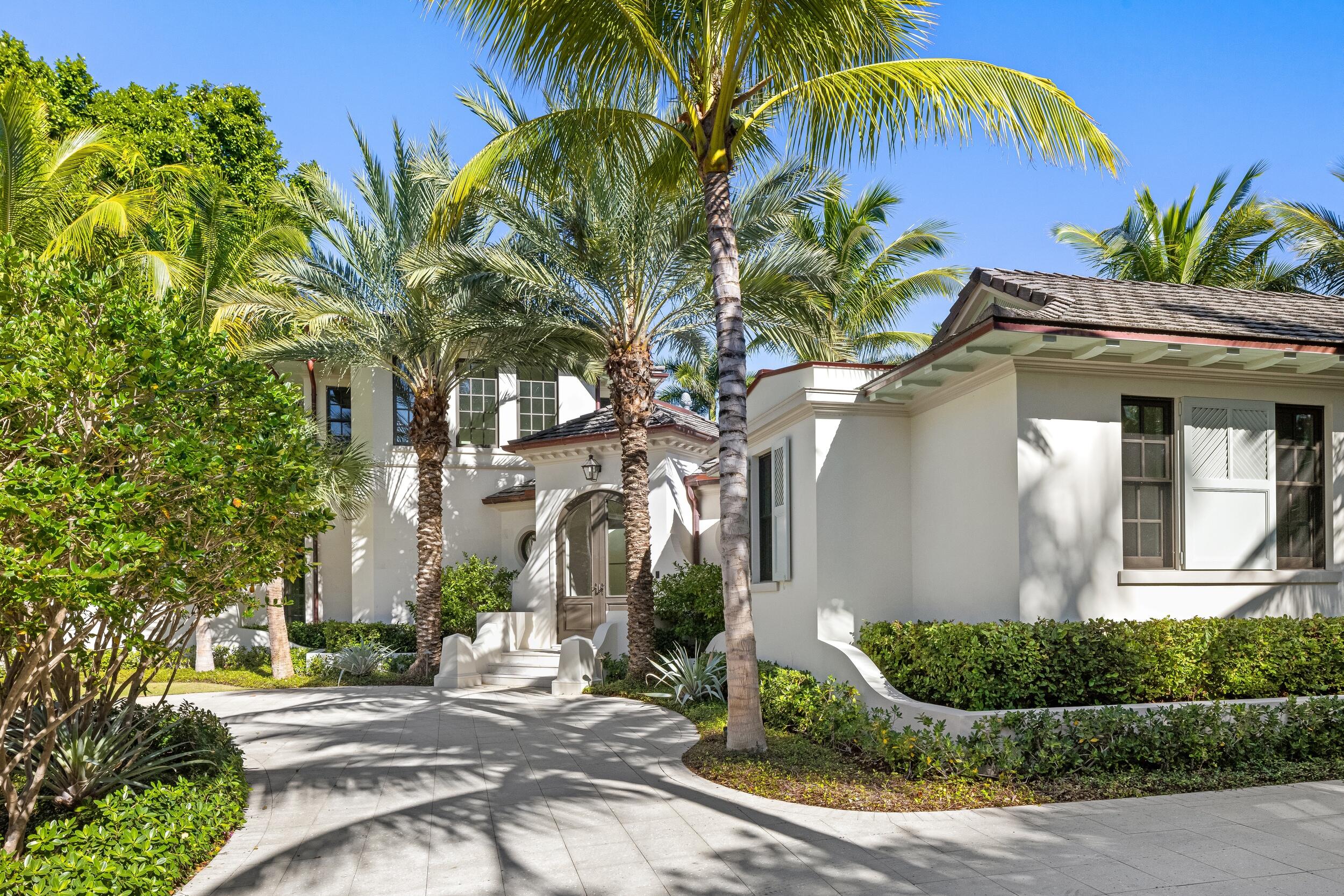 Tucked away on a quiet cul-de-sac on one of Palm Beach's most desirable in-town streets, this custom brand-new residence offers privacy, scale, and refined craftsmanship. Designed for comfort and ease of living, the home features a primary suite on the main level, and a three-car garage discreetly accessed via a private drive. An attached large guest house sits atop the three-car garage. Thoughtful architecture maximizes the oversized lot, surrounded by mature landscaping and a rare, landmarked tree that creates a private retreat just moments from town. Inside, wide-plank oak floors, marble accents, and top-of-the-line appliances reflect meticulous attention to detail throughout. A rare opportunity to own a beautifully executed home in a prime Palm Beach location