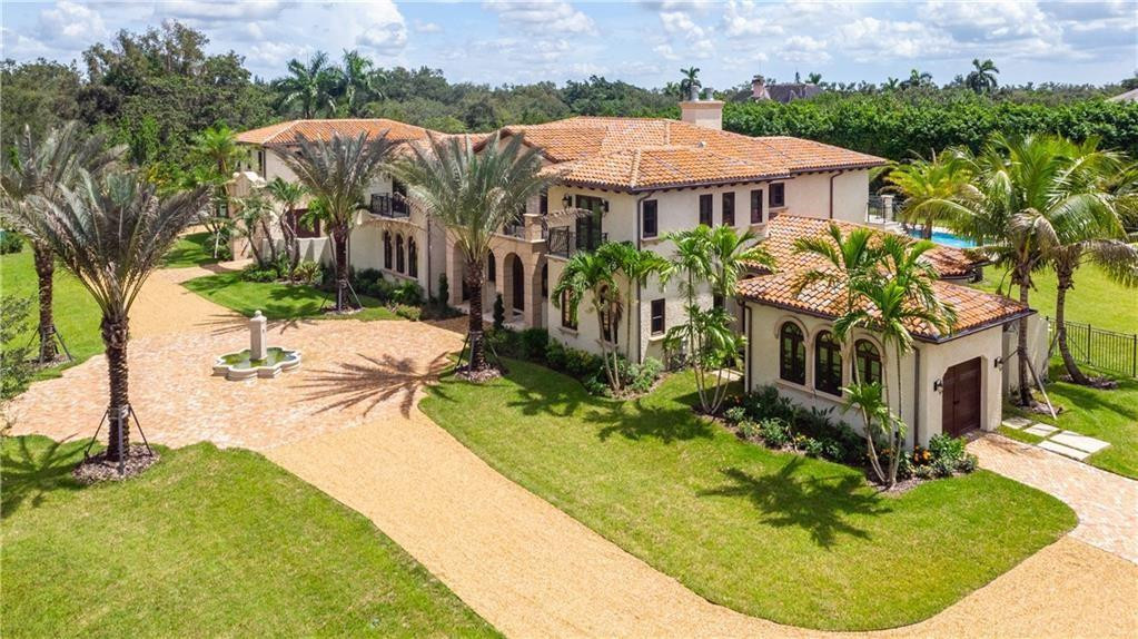 An architectural masterpiece in the heart of Sunshine Ranches! This stunning estate offers 12,300+ sq. ft. of refined luxury with a 6-bedroom main home featuring an office, media room, ballroom, maid’s quarters, and dual laundry rooms, plus a 2-bedroom, 2-bath guest house with motor court and 5 garages. Nestled on over 2 acres, it showcases exquisite craftsmanship, coffered ceilings, and designer finishes. The gourmet kitchen features custom cabinetry and a grand island. Enjoy a luxurious master suite, expansive verandas, full summer kitchen, and resort-style pool and spa surrounded by lush landscaping. Includes elevator, gas fireplace, and city water, a rare blend of tradition and modern elegance in Sunshine Ranches.