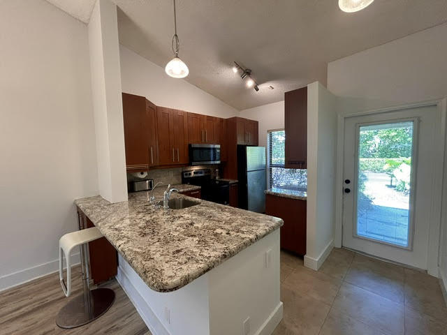 Two bed, two bath, corner unit with vaulted ceilings, washer dryer in unit, electric vehicle charging, screened patio and huge fenced outside courtyard perfect for your private garden, BBQ and entertaining. Bright, and spacious with updated kitchen and baths, plenty of closet space, and a nice "homelike" feel. Complex is gated, beautifully landscaped, with a lovely pool area, BBQ, clubhouse and fitness center, with views of the tranquil lake complete with spraying water fountain! Cable/internet and water, trash included. Available immediately.