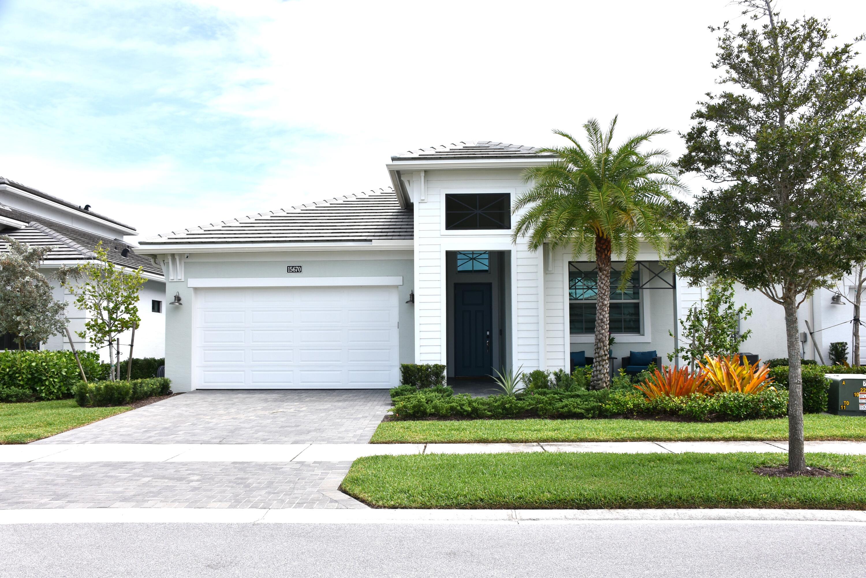 One year old home.  This Madison floorplan is situated on a waterfront homesite in a gated 55+ community.  The home features 3 bedrooms, 3 bathrooms, flex space (adding a door and closet could make this a 4 bedroom home), and a 2 car garage.  The kitchen is equipped with gas cooking and a 3" think quartz kitchen island, along with under cabinet LED lighting. There is convenient laundry room access through the owner's walk-in closet.  For added energy efficiency, the home includes spray foam insulation and a gas connector.  Enjoy the south-exposure Lanai with the beautiful lake view, complete with a 5-foot privacy wall. Backyard in fenced in and home has several electric window treatments.  Home shows and looks brand new.