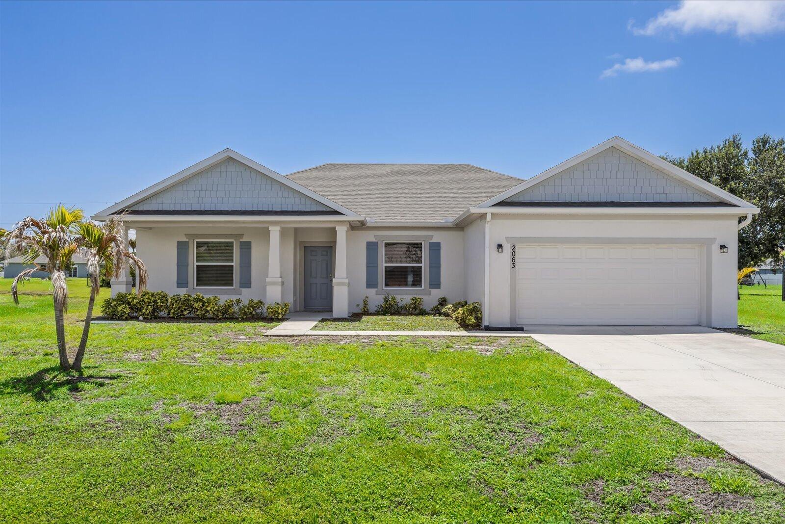 Welcome to this beautiful custom built 2023 waterfront home offering the perfect blend of modern comfort and peaceful outdoor living — all with NO HOA! Featuring 4 bedrooms and 2 bathrooms, this move-in ready property boasts a bright open layout with tile flooring throughout and a separate dining area ideal for entertaining or family gatherings. The spacious kitchen is equipped with upgraded appliances including a newer LG WiFi-enabled stove and an upgraded Whirlpool refrigerator.  Step outside to enjoy the fully fenced backyard overlooking the water, complete with a plum, fig, and an orange tree, creating your own private tropical retreat. Whether you're relaxing by the water or hosting guests, this home offers it all. LG ThinQ washer and dryer also included.