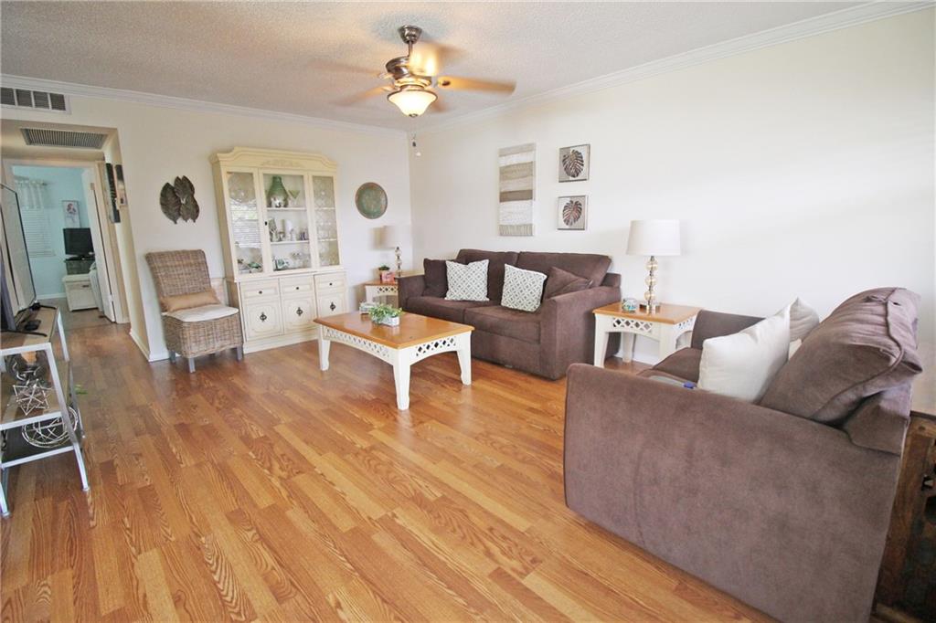 IMMACULATE CORNER UNIT IN GREAT LOCATION!! THIS BRIGHT 2 BEDROOM, 1.5 BATH HAS LOVELY LAMINATE FLOORS THRU-OUT!! CROWN MOLDING IN THE LIVING AREA GIVES IT AN ELEGANT TOUCH!! RENTABLE AFTER ONE YEAR OF OWNERSHIP!! HURRICANE ROLL UPS ON SCREENED PATIO WITH LOVELY VIEW OF GARDEN!! FIVE CEILING FANS TO HELP COOL THIS 2ND FLOOR CONDO!! AND THEN THERE ARE THE AMENITIES GALORE INCLUDING A LAVISH CLUBHOUSE WITH A 1,500 SEAT THEATER, A STATE OF THE ART GYM, TENNIS, INDOOR AND OUTDOOR POOL, CLASSES OF EVERY TYPE AND MORE. THIS GATED COMMUNITY HAS FREE TRANSPORTATION INSIDE AND OUT!! ASSOCIATION CLAIMS  55+!!