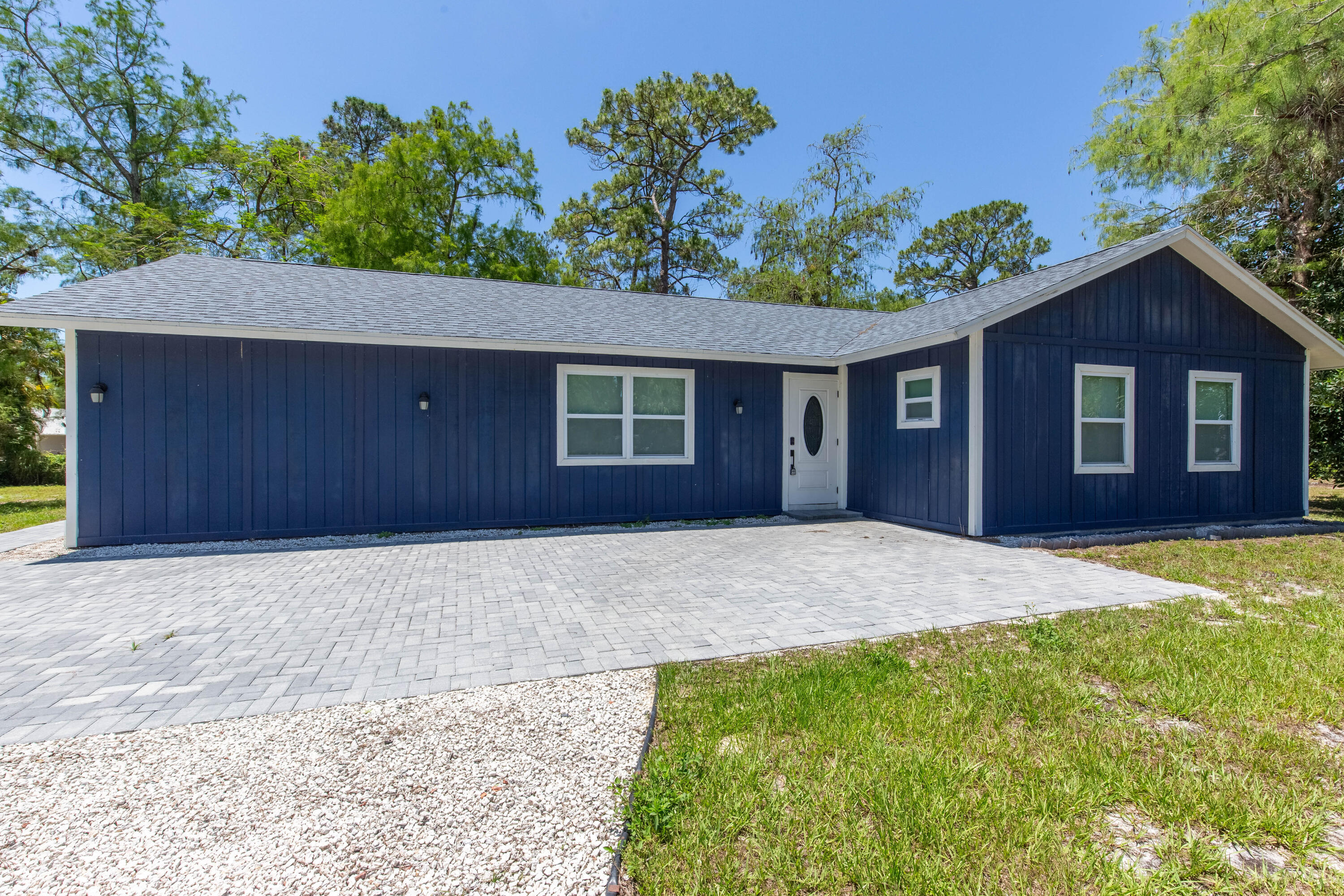 Welcome to this beautifully remodeled three bedroom, two bath home set on a spacious 1.20 acre lot. Recent upgrades include a 2024 roof, a modern kitchen with quartz countertops and premium appliances, renovated bathrooms, new tile flooring, and fresh interior and exterior paint. The home also features a newer water heater and a new washer and dryer. The expansive 1.20 acre lot provides exceptional outdoor space, privacy, and room for future improvements. This move in ready property offers a rare combination of modern finishes, extensive updates, and generous land in a highly desirable area of Loxahatchee.