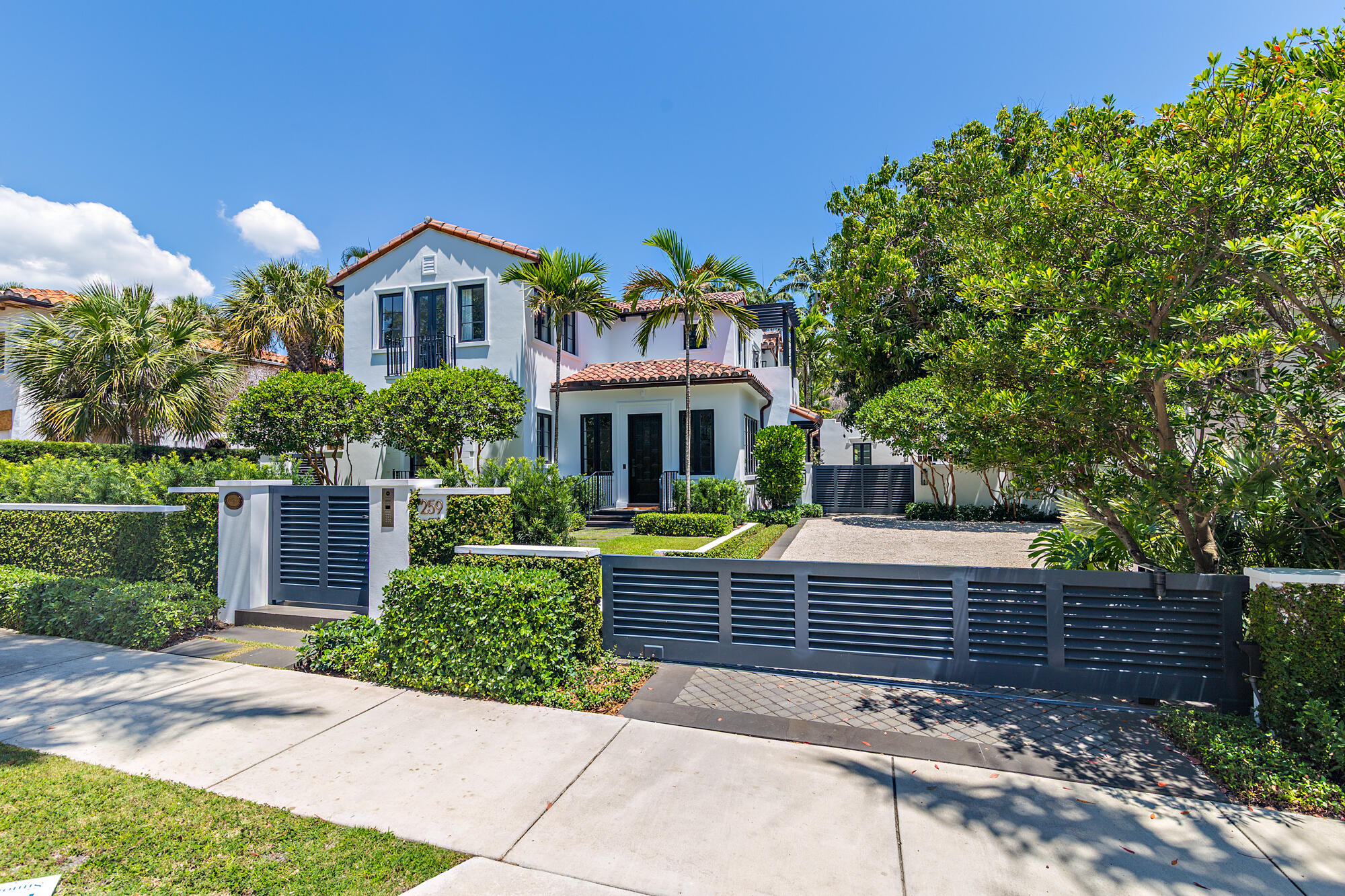 Tucked within the sought-after El Cid neighborhood, this stunning, double gated 4 bedroom, 4.5 bathroom Mediterranean-style estate with a private guesthouse is a crown jewel of timeless design. Created by Melhorn Architecture and featuring interiors by renowned designer Jeff Trotter, the home effortlessly blends historic charm with modern luxury. Step inside to exquisite herringbone hardwood floors and an abundance of natural light. The formal living room transitions seamlessly into an elegant dining area and a show-stopping media room (which could also serve as the fourth bedroom in the main house). The gourmet kitchen is a chef's dream, showcasing a Lacanche natural gas range and oven, honed marble countertops, and premium Sub-Zero appliances. Entertain with ease at the custom bar, outfitted with a fridge, freezer, and icemaker. The luxurious primary suite features a private terrace with water views and a spa-style bath with a marble-encased soaking tub, dual vanities, dual shower heads, and a private water closet. Upstairs, two additional bedrooms each feature ensuite baths and private balconies. The outdoor spaces are equally impressive, including a heated pool, Memphis Wood Pellet Grill, gas firepit, and an outdoor kitchen complete with a sink, refrigerator, and icemaker. A separate 1 bedroom, 1 bathroom guesthouse includes its own bar, offering a private space for guests. Additional features include a whole-house generator, Sonos sound system, Control4 smart home automation, central vacuum, and Kolbe impact windows.  This home is ideally positioned in the coveted Palm Beach Public School District and just steps from the Intracoastal Waterway and downtown West Palm Beach. This is a rare opportunity to own a truly exceptional residence in the heart of El Cid.