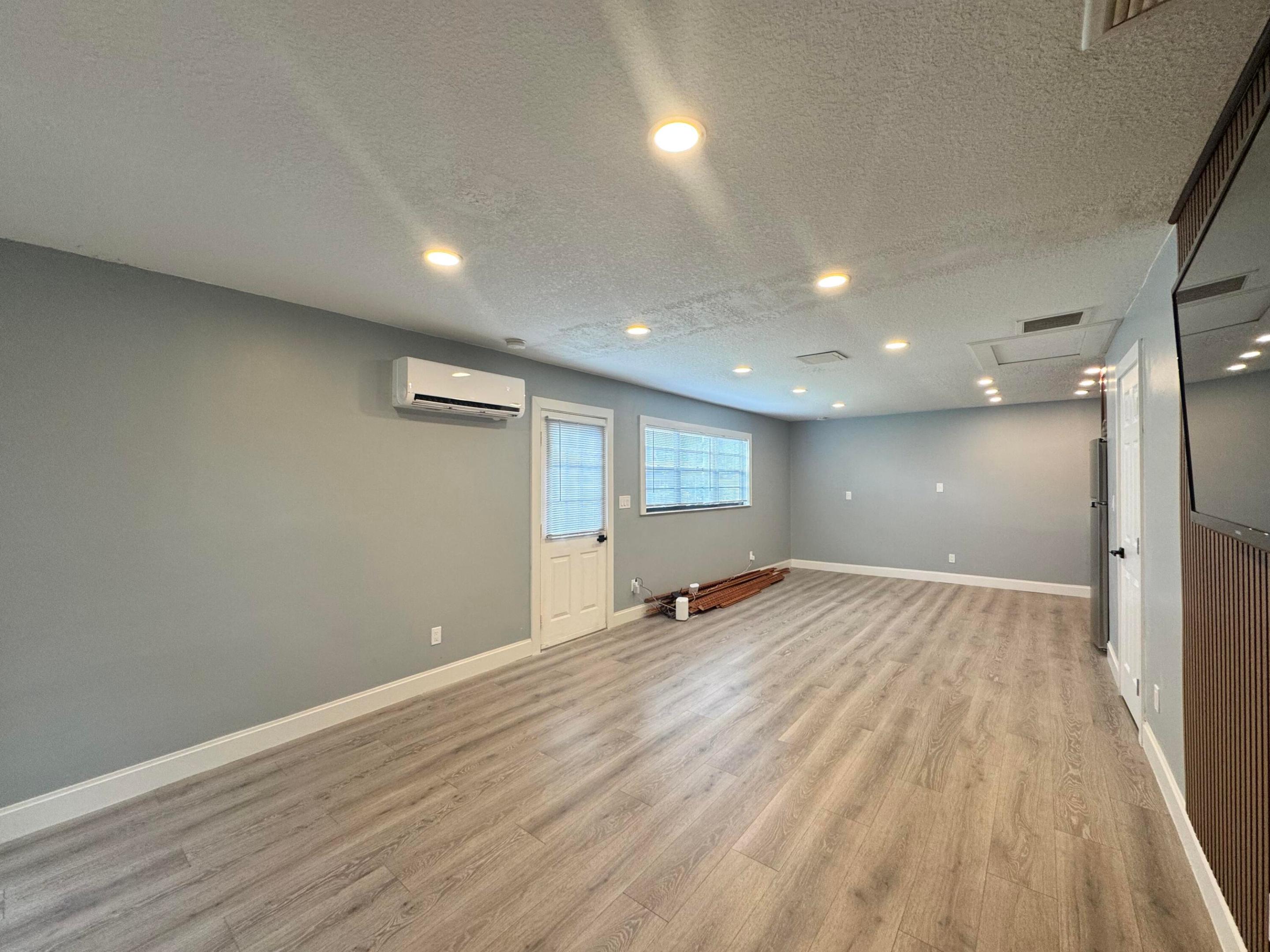 This 400 SqFt efficiency is fully independant & move in ready! All new kitchen & appliances, laminate floors, lighting and split A/C unit. The kitchen has soft close cabinets, quartz counters. cup washer, induction cooktop w/ 4 burners, stainless microwave and lots of storage. The unit already has pre-hung tv wall mount and TV (can be removed at tenants request). 4 windows in the unit provide ample natural light. 100% SEPARATE FROM MAIN HOUSE / PRIVATE ENTRANCE, LIVING SPACE & BATHROOM. WIFI & ALL UTILITIES INCLUDED. No smoking inside, pets are case by case.