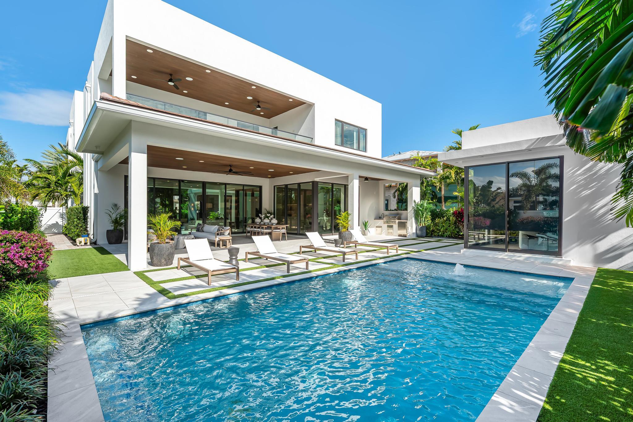 One-of-a-kind, turnkey home offered fully furnished with high-end designer decor and Restoration Hardware appointments thoughtfully curated throughout the entire residence.  Welcome to Boca Raton living at its finest in this bespoke smart estate on a corner lot, with a private and separate guest suite, crafted by Primo Construction and designer Arianna Tascione, moments from The Boca Raton Resort & Club, Mizner Park, pristine beaches, private aviation, and world-class dining and shopping.  The 391 sq ft separate 1-bed/1-bath guest suite distinguishes this masterpiece from neighboring homes, and provides complete privacy and functionality from the main house for use as a separate living space, a home office or a wellness suite. Inside, a centralized tablet orchestrates HVAC, lighting, security, exterior cameras, and motorized window treatments. A grand glass entry reveals a sculptural floating staircase above a gallery-worthy bonsai installation from The Plant Guy. Episode speakers and subwoofers powered by Sonos envelop both interior and outdoor spaces in immersive sound.  The chef's kitchen - natural gas Miele suite, oversized island, and built in bar - flows to an 833 sq ft covered patio with wood grain ceiling overlooking a lush pool and gardens. The primary retreat indulges with a 392 sq ft terrace, spa bath, dual custom closets (one bedroom sized), custom soaking tub and a steam shower. Two ensuite guest suites flank an entertainment loft, while a separate and private guest house adds maximum flexibility.  A concrete second floor structure, a full house built-in generator, and an ADA compliant elevator complete this no compromise modern sanctuary.  The custom, designer Restoration Hardware furniture and furnishings are offered for sale; and the price is negotiable.