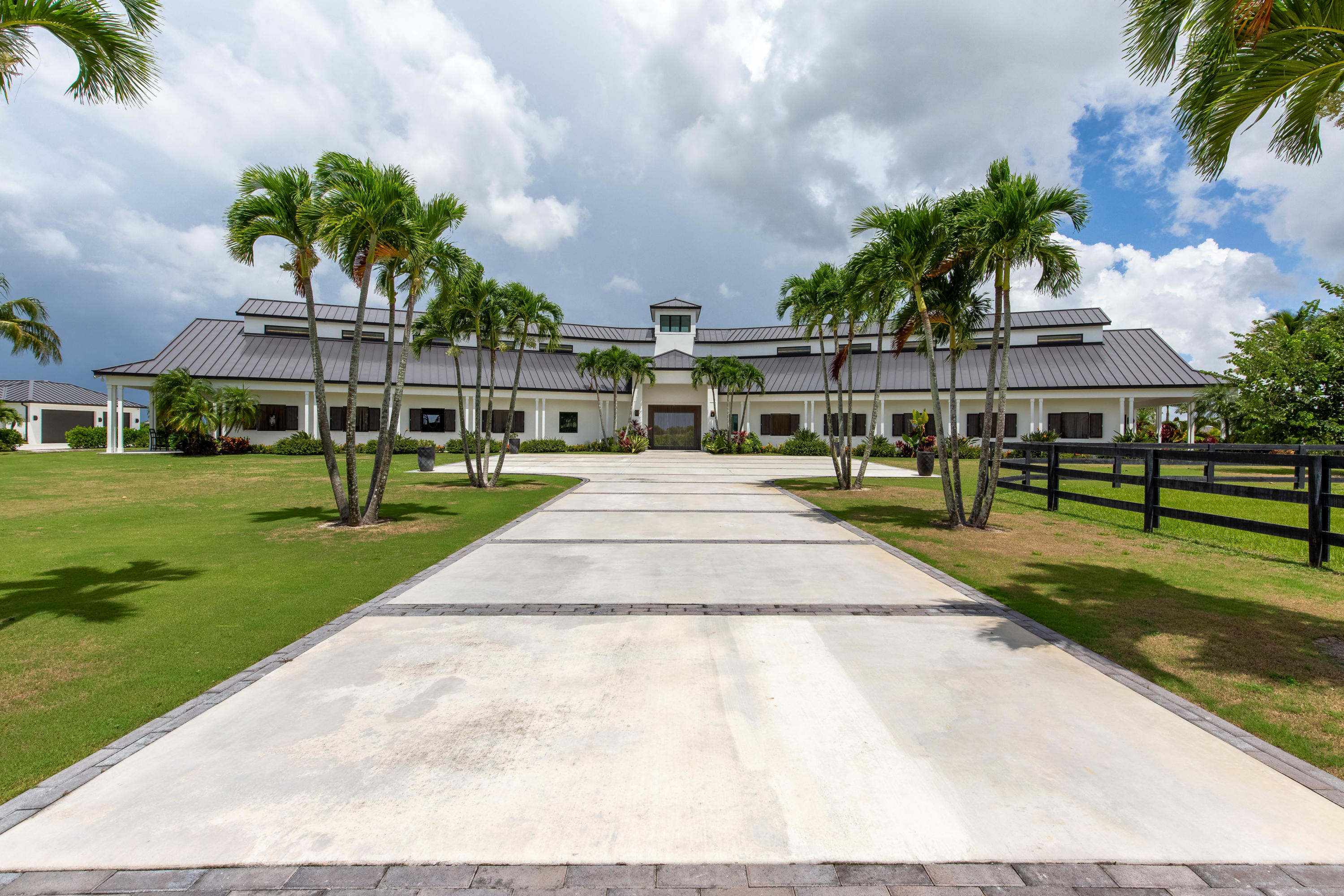 Exceptional opportunity to own a custom built, gated equestrian property on over 10 acres in the coveted Wellington Preserve! Featuring an extravagant main house with 4 beds, 4 full baths, an office, and an oversized 3-car garage. The stunning outdoor living space includes a resort-worthy pool, spacious covered lanai with a full outdoor kitchen and bar, and a one-bedroom pool house with kitchenette, full bathroom and two lanais. Built for the elite equestrian, the 14-stall barn includes interior and exterior wash stalls, vet/tack up area, feed and shavings rooms, air-conditioned lounge and tack room, and a full bath. This property is equipped with a 250'x140' all weather arena 150'x150' Grand Prix field, MK 6-horse walker, and a perimeter exercise track. The caretakers cottage ... has a living area with kitchen, 2 bedrooms, 2 bathrooms and a 3 car garage.