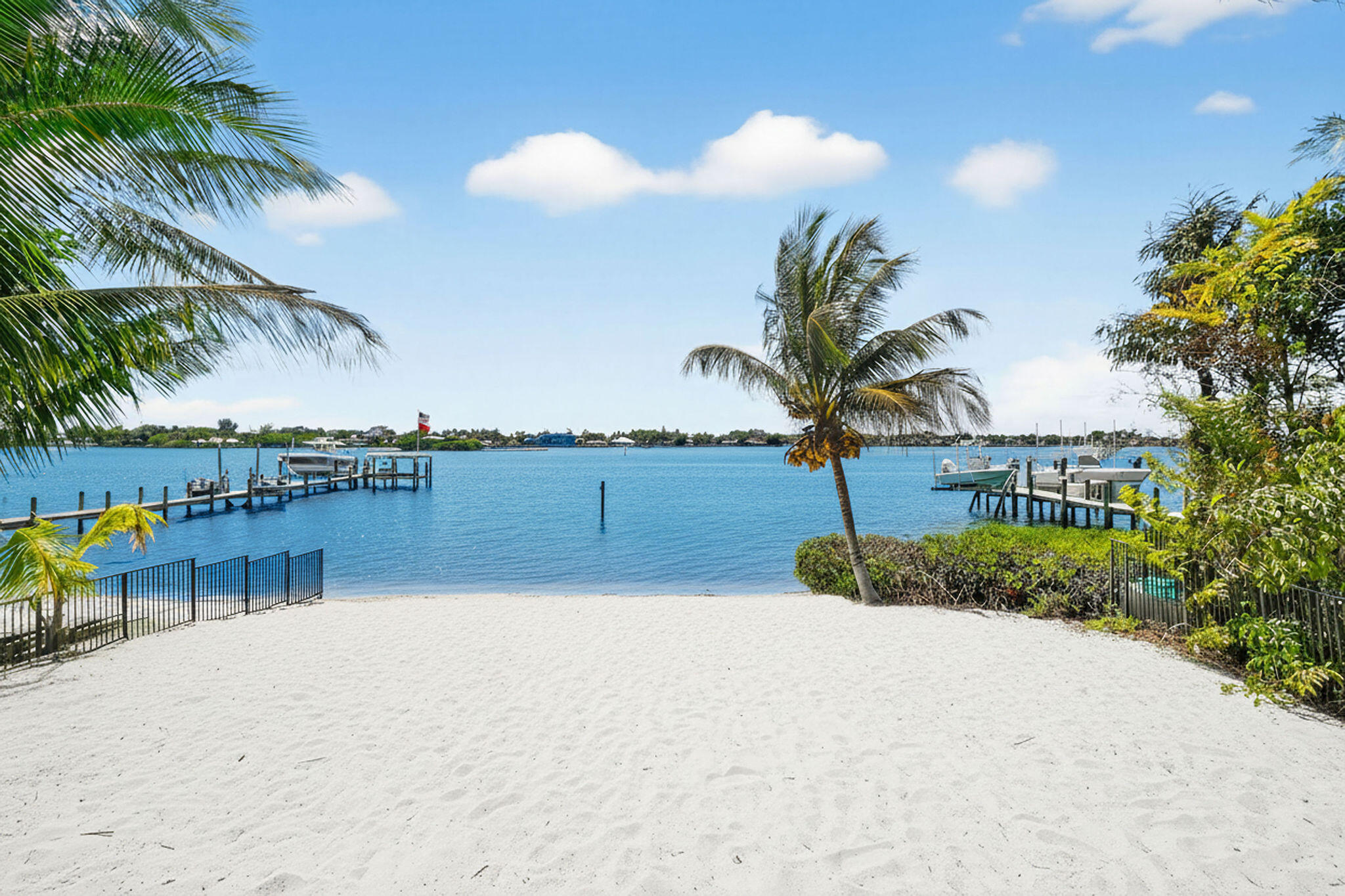 An unmatched opportunity awaits! This rare property is truly one-of-a-kind, offering a prime position at the mouth of the Loxahatchee River with 60 feet of pristine, private white sand beach. Stunning, sweeping views of the protected Loxahatchee River Preserve & the Jupiter Inlet, where natural beauty meets endless recreation. Launch a boat for a quick cruise down the Intracoastal, glide upriver on a paddleboard, or simply unwind as the sky transforms with vibrant sunsets over the water. Located on the widest part of the river and just minutes from fine dining, art galleries, boutique shopping, ocean beaches, and world-renowned golf courses, the lifestyle here is as convenient as it is exclusive. Set well back from the road and surrounded by lush, mature tropical fruit trees, the property offers exceptional privacy and the perfect canvas to create your dream estate. With the feel of a secluded nature sanctuary, this property is unlike anything else available. Opportunities like this are once in a lifetime. ** Some of the photos are digitally rendered.