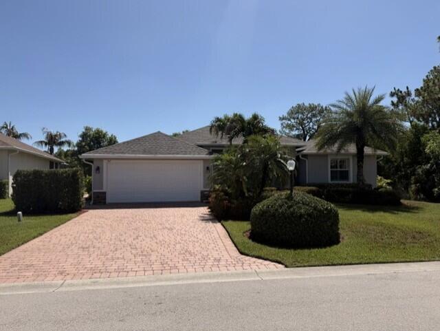 Beautiful home located just south of the Port St. Lucie border near Palm City, offering quick access to the Turnpike. This spacious 4-bedroom, 2-bath home sits in a desirable gated community with low HOA fees and private Boat/RV parking for residents.  The home features ceramic tile flooring throughout, a granite kitchen with 46-inch cabinets, and a generously sized primary bedroom with a large en suite bathroom. Positioned at the end of the street, the property offers added privacy along with serene lake and preserve views.