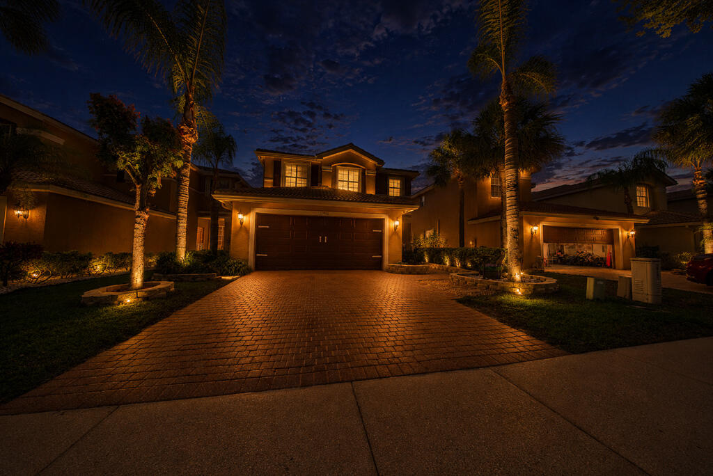 Welcome to this beautifully maintained 4-bedroom, 2.5-bathroom pool home offering 2,008 square feet of comfortable living space and a 2-car garage in the manned gated community of Nautical Lakes. From the moment you arrive, you'll appreciate the curb appeal featuring professional landscaping, a paved driveway and walkway, covered entry porch, durable tile roof, and accordion hurricane shutters for added peace of mind.  Inside, the bright and airy floor plan is enhanced by neutral colors, tile flooring throughout the main living areas, plantation shutters, ceiling fans, and a formal dining space perfect for entertaining. The kitchen features white cabinetry, stainless steel appliances, and ample storage. All four bedrooms are conveniently located upstairs, along with the laundry room complete with washer, dryer, and storage shelving. The spacious primary suite offers a tray ceiling, large walk-in closet, dual vanities, a privacy toilet, and a walk-in shower with built-in seating. Major updates include a 2019 A/C system and 2014 water heater.  Step outside to your own private backyard retreat. Enjoy Florida living in the sparkling pool built in 2016, a new pool pump installed in 2023, relaxing spa, spacious sundeck, retractable awning, and fully fenced backyard. Tha home also includes pre-installed permanent exterior Govee smart lighting, offering customizable colors and effects for year-round accent and holiday lighting. Nautica Lakes community in Royal Palm Beach boasts resort-style amenities including a clubhouse, fitness center, community pool, tennis courts, basketball courts, playgrounds, and beautifully maintained common areas. Nautica Lakes is conveniently situated near top-rated schools, shopping, dining, parks, golf courses, and major commuter routes including Southern Boulevard and Florida's Turnpike. Just minutes away are popular destinations such as Commons Park, Calypso Bay Waterpark, Wellington's equestrian venues, and numerous shopping and entertainment options, making this an ideal location to enjoy everything Palm Beach County has to offer.