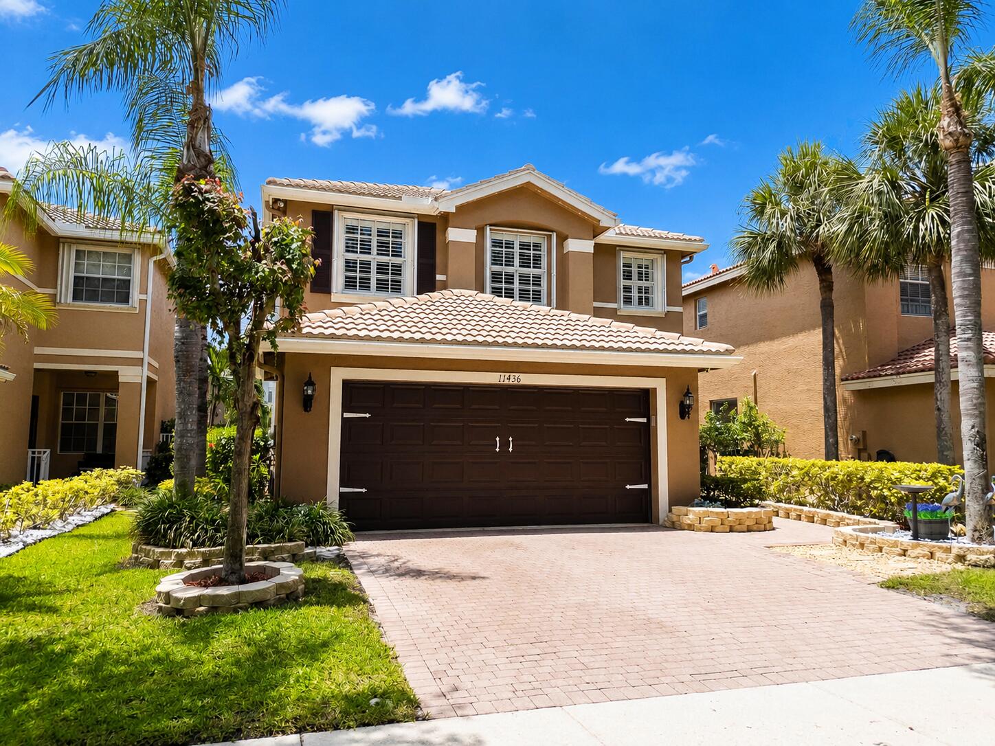 Welcome to this beautifully maintained 4-bedroom, 2.5-bathroom pool home offering 2,008 square feet of comfortable living space and a 2-car garage in the manned gated community of Nautical Lakes. From the moment you arrive, you'll appreciate the curb appeal featuring professional landscaping, a paved driveway and walkway, covered entry porch, durable tile roof, and accordion hurricane shutters for added peace of mind.  Inside, the bright and airy floor plan is enhanced by neutral colors, tile flooring throughout the main living areas, plantation shutters, ceiling fans, and a formal dining space perfect for entertaining. The kitchen features white cabinetry, stainless steel appliances, and ample storage. All four bedrooms are conveniently located upstairs, along with the laundry room complete with washer, dryer, and storage shelving. The spacious primary suite offers a tray ceiling, large walk-in closet, dual vanities, a privacy toilet, and a walk-in shower with built-in seating. Major updates include a 2019 A/C system and 2014 water heater.  Step outside to your own private backyard retreat. Enjoy Florida living in the sparkling pool built in 2016, a new pool pump installed in 2023, relaxing spa, spacious sundeck, retractable awning, and fully fenced backyard. Tha home also includes pre-installed permanent exterior Govee smart lighting, offering customizable colors and effects for year-round accent and holiday lighting. Nautica Lakes community in Royal Palm Beach boasts resort-style amenities including a clubhouse, fitness center, community pool, tennis courts, basketball courts, playgrounds, and beautifully maintained common areas. Nautica Lakes is conveniently situated near top-rated schools, shopping, dining, parks, golf courses, and major commuter routes including Southern Boulevard and Florida's Turnpike. Just minutes away are popular destinations such as Commons Park, Calypso Bay Waterpark, Wellington's equestrian venues, and numerous shopping and entertainment options, making this an ideal location to enjoy everything Palm Beach County has to offer.