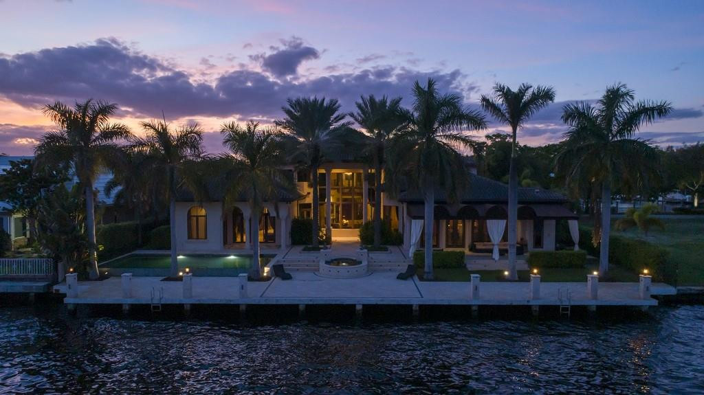 Gated & Secured Bay Colony Intracoastal Estate on 120 Ft of Direct Intracoastal Frontage at Rear of Home Plus an Additional 120 Ft of Protected Deep Water Dockage Directly Across the Street at Front of Home. Accommodates up to 100 Ft Mega-Yacht. Infinity Edge Pool, Impact Glass & Home Theater. High Ceilings Throughout. Two Story Great Room: Floor to Ceiling Stone Fireplace, Wet Bar, Two Story Walls of Glass & Stone Floors.  Curved Wrought Iron & Wood Staircase. Ground Floor Master Has High Tray Ceilings, His & Her Baths. Richly Paneled Library/Office.  Kitchen with Wolf Gas Cooking, Mosaic Backsplash & Butler's Pantry. Family Room with Coffered Ceilings & Built-In Media Center. Covered Loggia with Large Waterside Jerusalem Stone Patio & Concrete Dock Featuring Heated Pool & Spa.
