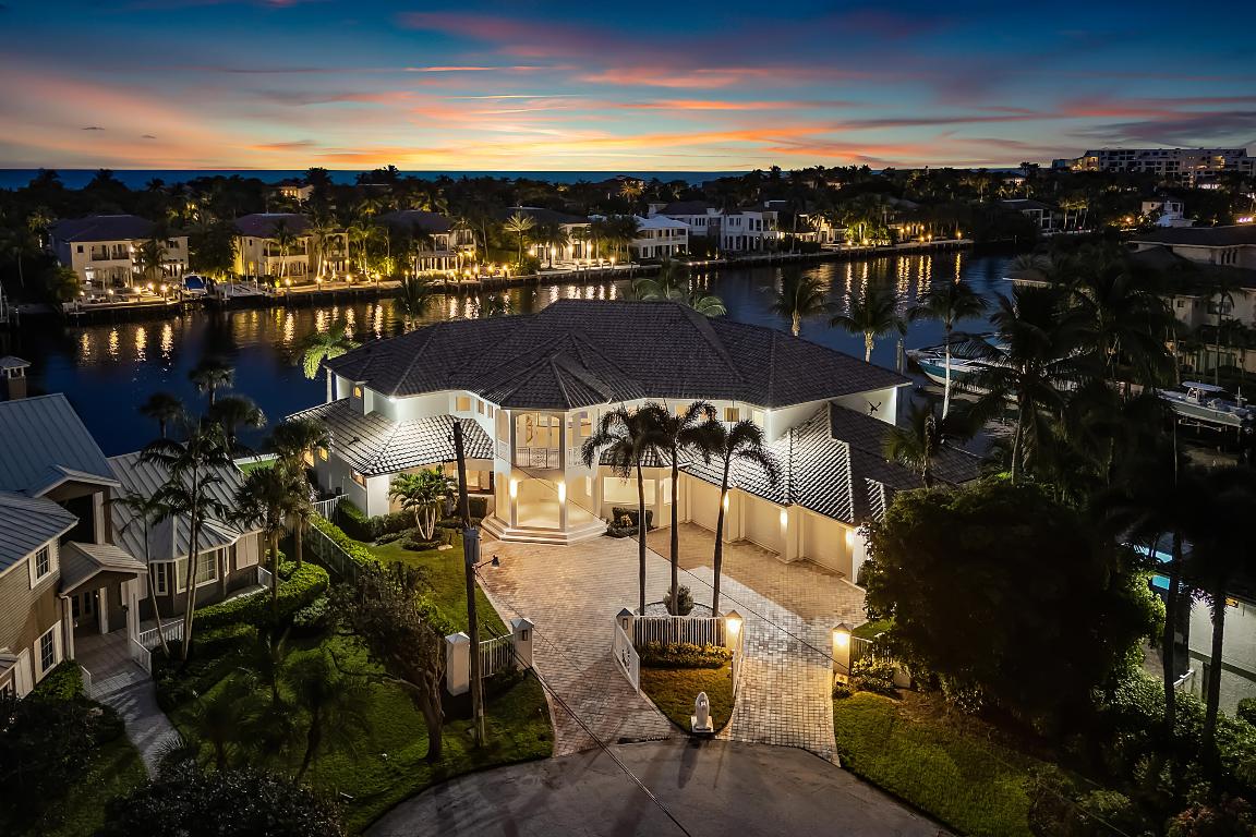 This extraordinary waterfront residence offers over 7,300 square feet under air, plus an additional 2,000 square feet of covered outdoor living space and balconies, creating a seamless indoor-outdoor lifestyle. Thoughtfully designed for both elegance and comfort, the home features five bedrooms and nine bathrooms, including two primary suites, one on each level. Situated on a coveted point lot in Delray Beach, the property boasts 126 feet of direct Intracoastal frontage and 125 feet of canal frontage, with direct ocean access and no fixed bridges! Boating amenities include a 50-foot dock with electric service, ample room to extend, and a 100-foot-wide canal, allowing for effortless yacht maneuvering and docking. From the moment you enter, you are greeted by panoramic water views from every room. Construction quality is truly exceptional, featuring metal stud framing and a concrete lay-in second floor, providing superior strength, durability, and soundproofing well beyond traditional block construction. Additional highlights include  soaring ceilings throughout, a full house generator, temperature-controlled walk in wine cellar, five zone air conditioning, impact rated doors and glass, and pre wiring for smart home audio, lighting, and sound system integration. Designed for the most discerning buyer, this residence combines architectural integrity, exceptional craftsmanship, and one of the most desirable water exposures southeast facing on the Intracoastal.