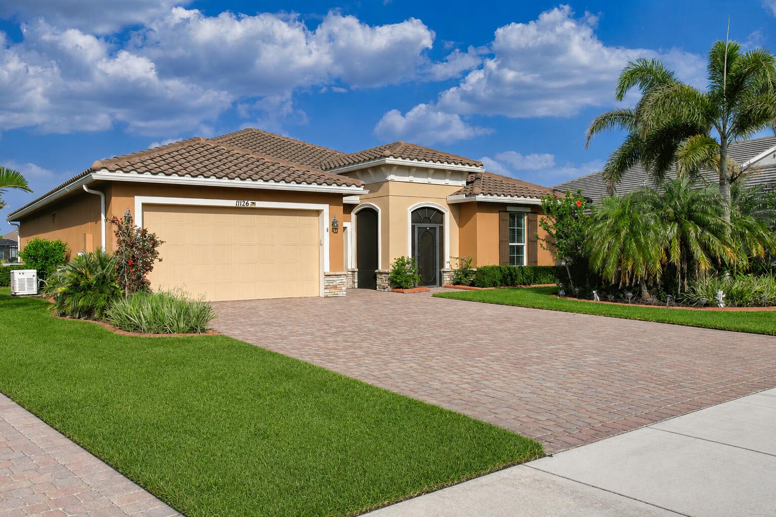 Discover the highly desirable Perdido Key model in Vitalia at Tradition. This meticulously maintained, one-owner waterfront home features 3 bedrooms, office/den, 2 full baths, 1 half bath, and a spacious 2-car plus golf cart garage. The open-concept design offers soaring ceilings, abundant natural light, and a well-appointed kitchen overlooking the living areas and tranquil lake views. Relax and entertain on the screened lanai with a jacuzzi, the perfect place to enjoy Florida's indoor-outdoor lifestyle. Additional highlights include a whole-house generator for added peace of mind. Enjoy resort-style amenities, including pickleball, tennis, a fitness center, clubhouse, and the vibrant lifestyle that makes Vitalia one of Tradition's premier 55+ communities.
