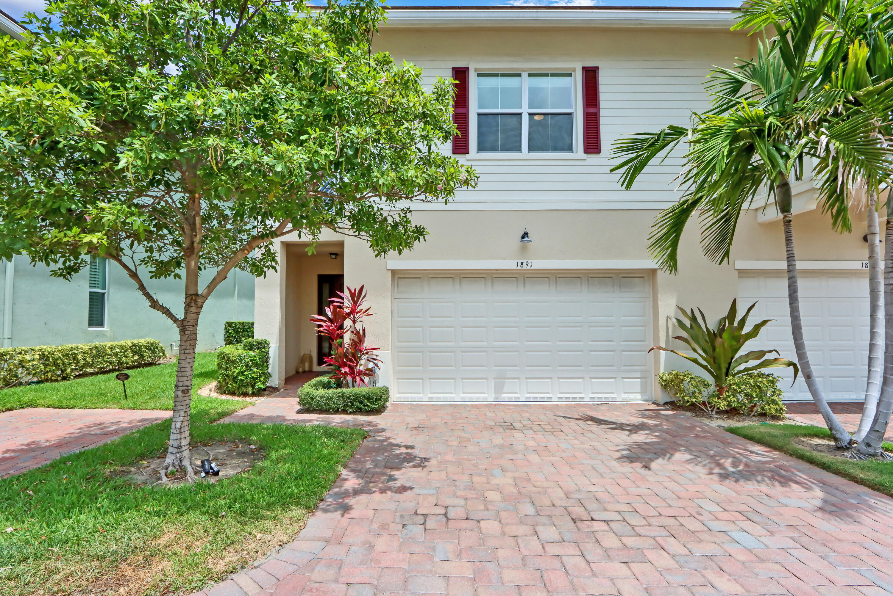 Nestled within the gated community of Hampton Cove, this beautiful 3 bedroom/2.5 bath corner unit townhome offers the rare convenience of a 2-car garage and comes designer furnished. The open-concept layout features an updated kitchen with stainless steel appliances, custom cabinetry, and a spacious island, flowing into the living areas and private patio. The Primary suite includes dual walk-in closets, a spa-like bath, and private balcony. Residents enjoy a heated resort-style pool and an exceptional location just minutes from beaches, golf, shopping, fine dining, and 20 minutes to PBI. Also offered seasonally at $8,650 per month, this turnkey residence presents an exceptional opportunity to enjoy the best of South Florida living. Don't miss this incredible opportunity!