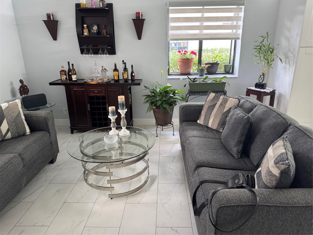 ALL AGES , Huge 1st-floor corner unit with nearly 1,500 sq ft in the gated community of Bonaire at Woodmont! Fully renovated kitchen and bathrooms. Brand new A/C and water heater. The den can be converted to a 3rd bedroom. Enjoy a private front entry with a screened porch and an oversized walk-out screened patio, just steps from the community pool. Spacious master suite features two walk-in closets and a vanity dressing area. Separate laundry/utility room with abundant storage. The large kitchen opens to a bright family room/den with a charming garden window. Small pets allowed. No leasing permitted.