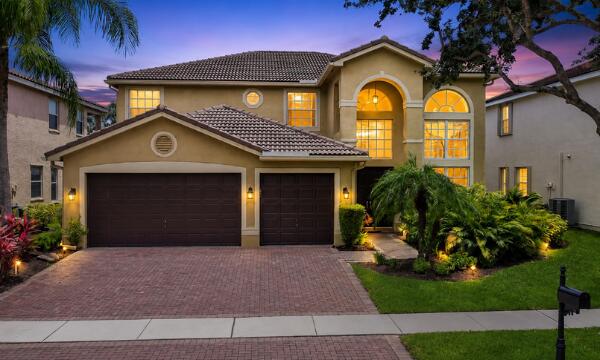 Welcome to your private tropical oasis in the prestigious, guard-gated community of Saturnia. This magnificent 2-story Mediterranean-style estate features 4 spacious bedrooms, 3.5 bathrooms, & a versatile 2nd floor loft & spacious balcony. As you step inside, you are greeted by a grand 2-story living room with soaring ceilings & abundant natural light pouring through elegant arched windows. The open-concept kitchen boasts honey-maple cabinetry, premium granite countertops, a large island with bar seating, & a seamless flow into the spacious family room, which opens to a spectacular, long lake-view backyard sanctuary. Here, you can relax by your large sparkling pool while enjoying serene, unobstructed lake views.  *Preferred lender credit up to $6,200 available.*