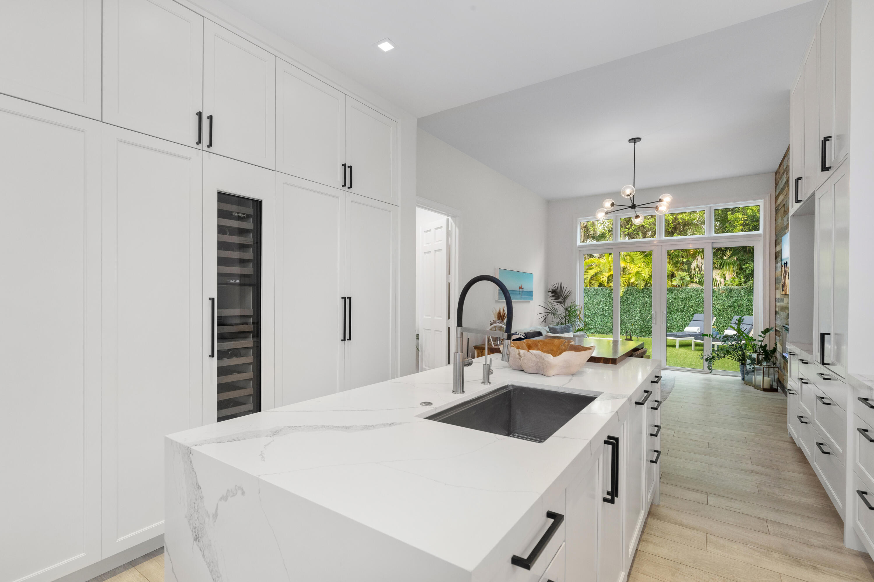 Experience island living at its best in this renovated 4,220SF estate within Grand Bay Estates, Key Biscayne's only guard-gated single-family enclave! This 5BR/5.5BA home features a 2021 roof, new tankless water heaters, new AC units and full storm protection! The kitchen shines with Quartz counters & Sub-Zero, Wolf, & Miele appliances, plus a dual-zone Sub-Zero wine fridge. The versatile layout includes all en-suite bedrooms, staff quarters, & private in-law suite with its own entrance. A rare find for Key Biscayne is the climate controlled 2-car garage plus golf cart garage. The backyard oasis offers a heated saltwater pool, summer kitchen & retractable awnings, perfect for entertaining! HOA covers lawn care, 24hr security, pool maintenance, pest control, plus private park & playground! For the ultimate experience in luxury and privacy, look no further!