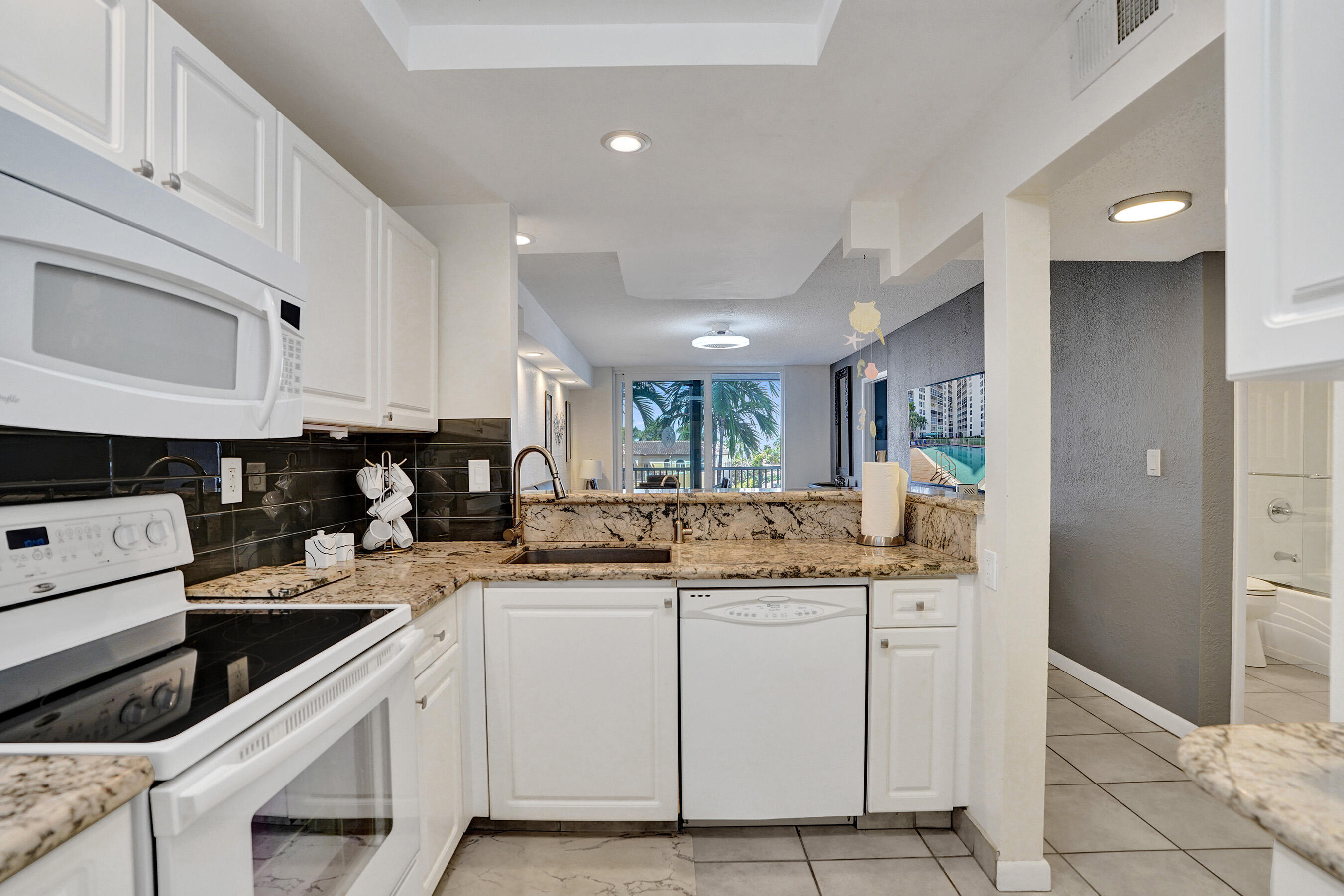 Beautiful 2BR/2BA corner rental in East Pompano Beach, directly across from the beach with tranquil canal views. This coastal retreat features an bright open-concept design, with granite countertops, creating a seamless flow for elegant living and entertaining. Split-bedroom layout with hurricane impact windows and private screened balcony. Laundry facilities on each floor, private storage bin, Olympic-sized pool. Small pets welcome. Enjoy private beach access across the street, providing a relaxing oceanfront retreat.