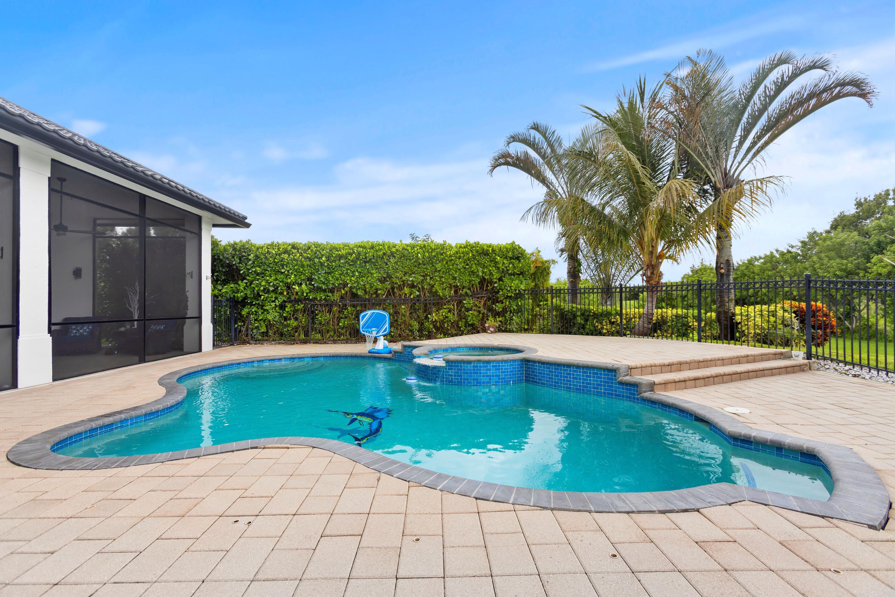Welcome to this waterfront single-family residence nestled in the prestigious Cobblestone community of Palm City, Florida. This 2023 thoughtfully designed one-story home offers 2,704 square feet of finished living space with four bedrooms and three full bathrooms to accommodate all your needs. The three-car garage provides ample storage and parking convenience for multiple vehicles. As a waterfront property, this residence captures the essence of Florida living with direct water access that enhances both your lifestyle and property value. Discover the perfect blend of comfort and convenience in this well-appointed Cobblestone home. Completely transformed from the inside out, this exceptional 2023 Palm City home offers the peace of mind and luxury feel of new construction within an established community setting. The property was stripped down to the concrete floors and studs before being thoughtfully rebuilt with quality craftsmanship and high-end finishes throughout. Major upgrades include new plumbing, electrical, AC systems and ductwork, spray foam insulation, impact windows and sliders, hurricane-rated garage doors, new well and water system, new hot water heater, and a premium metal tile roof engineered for durability and Florida living. The open and airy interior features soaring ceilings, luxury flooring, designer lighting, custom cabinetry, quartz surfaces, beautifully renovated bathrooms, and a stunning gourmet kitchen centered around an oversized mitered-edge island ideal for entertaining. Outdoor living is equally impressive with updated pool features, LED lighting, spacious entertaining areas, and a private setting designed to embrace the Florida lifestyle. This is a rare opportunity to own a truly move-in-ready home where nearly every major component has already been upgraded and thoughtfully redesigned.
