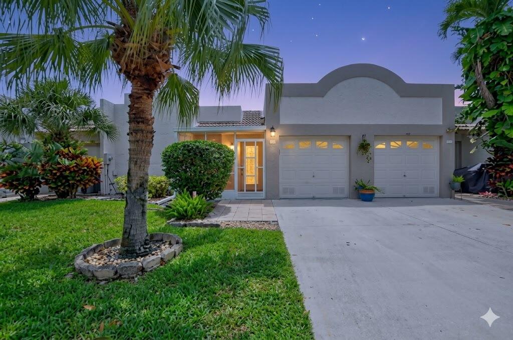 FULL IMPACT DOORS & WINDOWS!! Welcome to this beautiful, move in ready 2 bedroom, 2 bathroom villa located in the highly desirable 55+ community of Town Villas in Boca Raton. This residence combines modern upgrades, comfort, and peace of mind in one of Boca Raton's most convenient active adult locations. Enjoy true Florida indoor outdoor living with both a screened in covered front patio and a screened in rear patio. Additional highlights include ALL IMPACT doors and windows for enhanced safety, storm protection, and energy efficiency, a 1 car garage, in unit washer and dryer, and upgraded light fixtures and ceiling fans throughout. Step inside to a bright and open floor plan featuring fresh interior paint, modern finishes, and a seamless flow between the living and dining areas ideal for both everyday living and entertaining. Throughout the main living area, you will find high quality large format tile flooring with a white finish and elegant marble like veining that adds a clean and sophisticated touch.  The kitchen is a true showpiece and masterclass in modern efficient design, blending high tech convenience with a clean monochromatic aesthetic. Fully renovated and thoughtfully designed, it features a premium stainless steel appliance package including a Samsung smart refrigerator with touchscreen display, a stainless steel double oven, stainless steel dishwasher, and a matching over the range microwave. Crisp white cabinetry, pristine stone countertops, and a sleek minimalist backsplash create a bright contemporary feel, while modern pendant lighting and large format tile flooring complete the space with a polished upscale finish.  The spacious primary suite offers a relaxing retreat with a generous closet featuring a California Closet organization system, along with an ensuite bathroom complete with a walk in shower and separate vanity. The 2nd bedroom offers excellent flexibility for guests, a home office, or additional living space and is conveniently connected to the guest bathroom.  Residents of Town Villas enjoy a well maintained and active 55+ lifestyle community featuring a welcoming clubhouse and resort style amenities designed for social living, recreation, and relaxation. The community offers a vibrant atmosphere with planned activities and gathering spaces that foster connection and convenience right outside your door. Ideally located in Boca Raton, this home is just minutes from world class shopping, dining, and entertainment including Town Center at Boca Raton, Mizner Park, and a wide selection of local restaurants and cafés. Nearby parks, walking paths, and golf courses offer endless outdoor recreation, while easy access to major roadways keeps everything South Florida has to offer within reach.
