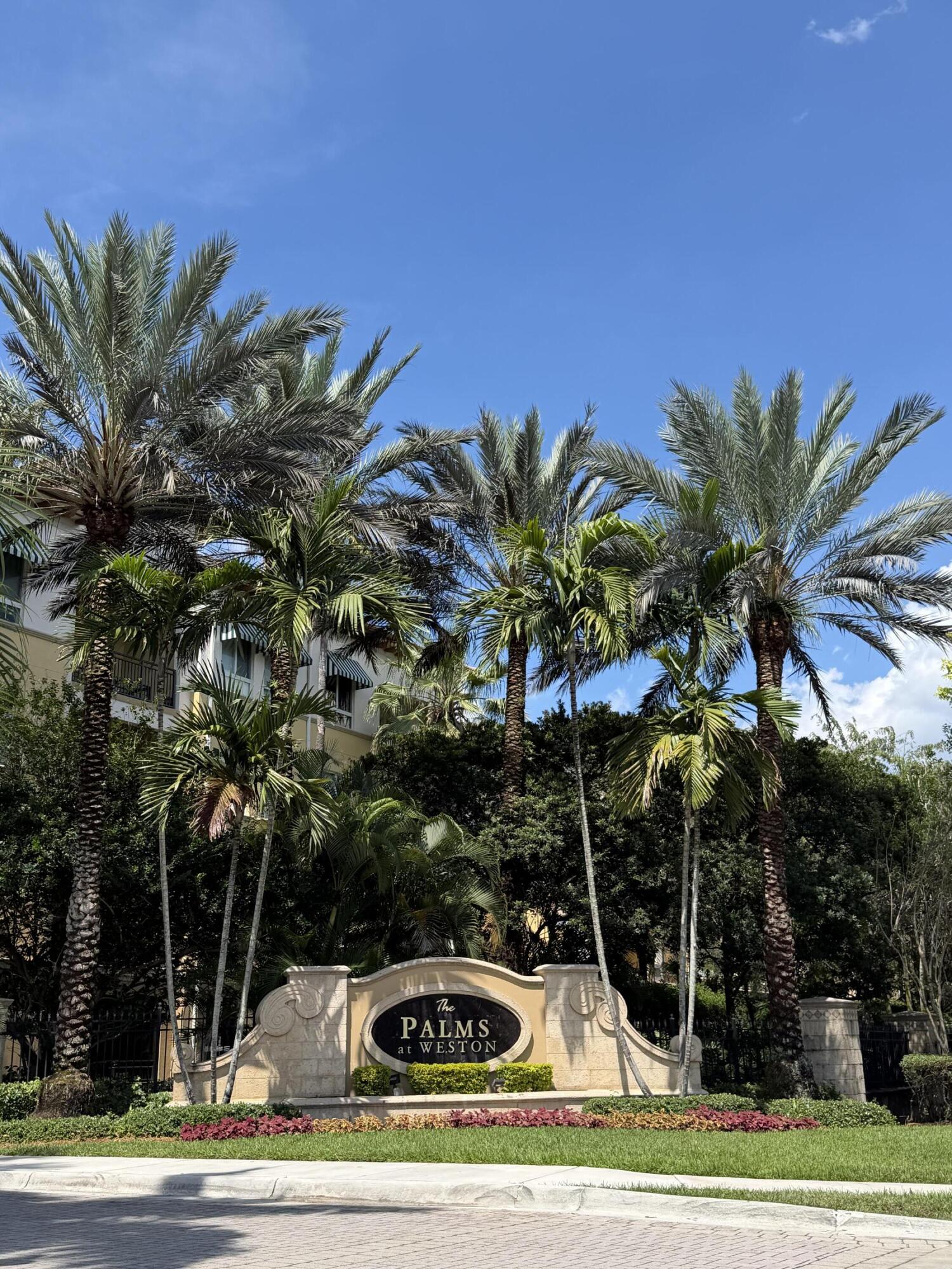 Welcome to resort-style living at The Palms at Weston — one of Weston's most desirable 55+ communities. This spacious 1-bedroom, 1.5-bath corner unit is located on the first floor of the main building and features soaring high ceilings that create an open and airy feel throughout. Enjoy the convenience and comfort of two private balconies, perfect for morning coffee, relaxing evenings, or entertaining guests. The thoughtfully designed layout offers abundant natural light, generous living spaces, and the ease of first-floor access. Residents enjoy a vibrant resort-style lifestyle with outstanding amenities including a beautifully maintained clubhouse, sparkling pool and spa, fitness center, social activities, walking paths, library, game rooms, and more. living in the heart of Weston.