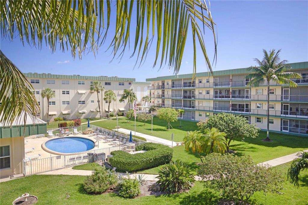 Don't miss out on this rare 2/2 in this lovely 55+ community! Assigned covered parking comes with this unit that is close to shops and restaurants. Wonderful views from the screened patio overlooking he pool, green space and recreational areas. Newer accordian shutters, air conditioner and hot water heater. Just some TLC will make this a wonderful place to call home. Community has two pools clubhouse and more - all this and just a short drive to the beach!