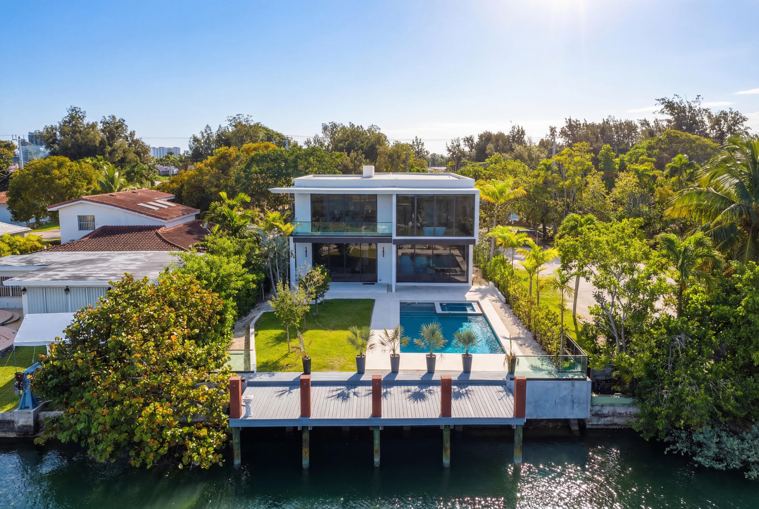 Furniture included, move-in ready, this brand-new 2026 waterfront estate is offered under $9M. Located in the guard-gated Normandy Shores island community, the residence spans approx. 5,229 SF with 5 bedrooms, 5 baths, and 1 powder room.  Designed for comfort and sophistication, it features a private elevator, Scavolini kitchen with Gaggenau appliances, Italian flooring, and a natural gas generator.  Outdoors, enjoy 60 ft of seawall, a 36-ft private dock with direct Biscayne Bay access (one fixed bridge), and a resort-style pool, plus a community playground. Residents also enjoy an 18-hole golf course, newly renovated tennis center, and no mandatory HOA.