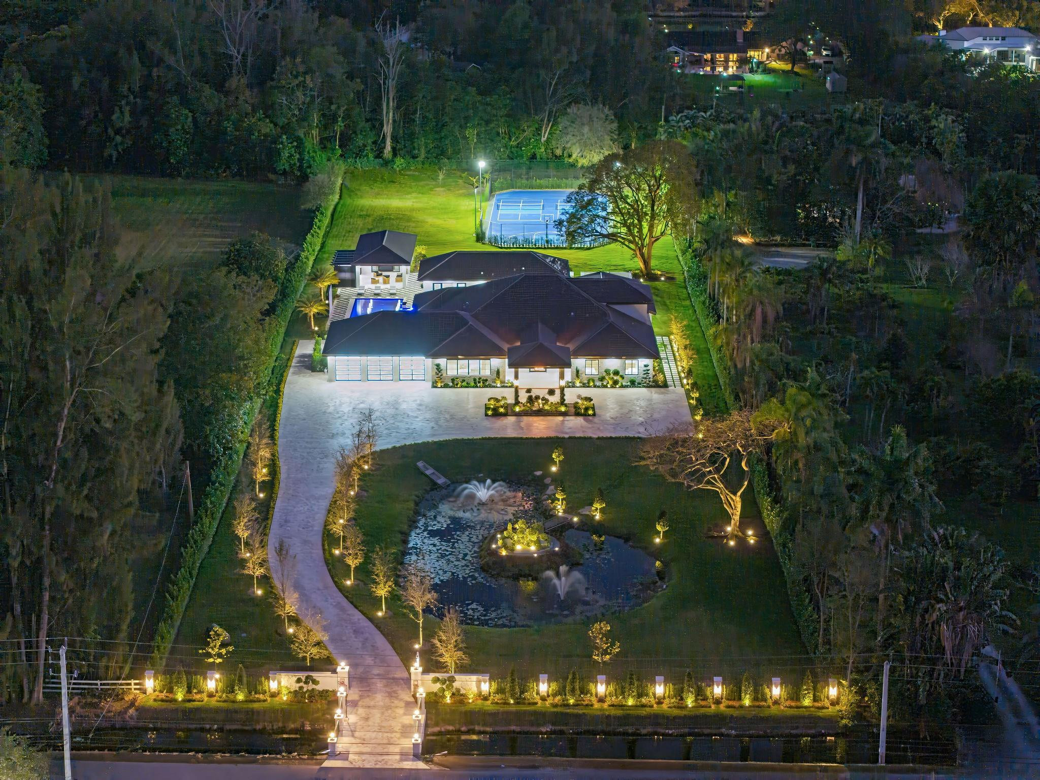 Located in prestigious Sunshine Ranches, this ultra-luxury estate showcases elite finishes and exceptional attention to detail. The 4 bedroom, 4 full bath, 1 half bath home with office and multi-purpose media room features white oak beam ceilings, custom cabinetry, imported stone, double-sided fireplace, wine cellar, LED bar, chef’s kitchen with gas range and double islands, and 4-car garage. Fully integrated smart home. The grounds impress with lush landscaping, a beautiful pond with fountain, pickleball court, half basketball court, air-conditioned gym, summer kitchen, and gazebo — a private resort-style setting that must be seen in person, offering unmatched privacy, scale, and presence.