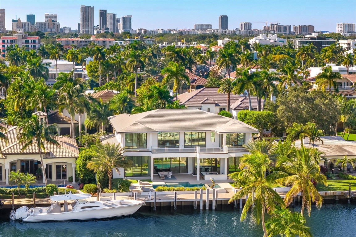 Premiere Las Olas living meets new-construction luxury on one of the most coveted streets in the Isles w underground utilities & one of the widest, deepest canals. This warm contemporary Estate showcases a rare, long view straight down the waterway & sits on 100' w a new seawall, concrete dock & turning basin for easy ocean access. Find a double-height entry, 12' ceilings & top-of-the-line finishes throughout. An expansive first-floor primary suite anchors the home, joined by multiple guest suites, an office, club room w bar, wine room, floating staircase, commercial-grade elevator & expansive second floor balcony. Resort-style outdoor living features a heated saltwater pool, summer kitchen & sunken bar; all supported by full smart-home automation & a full house generator.