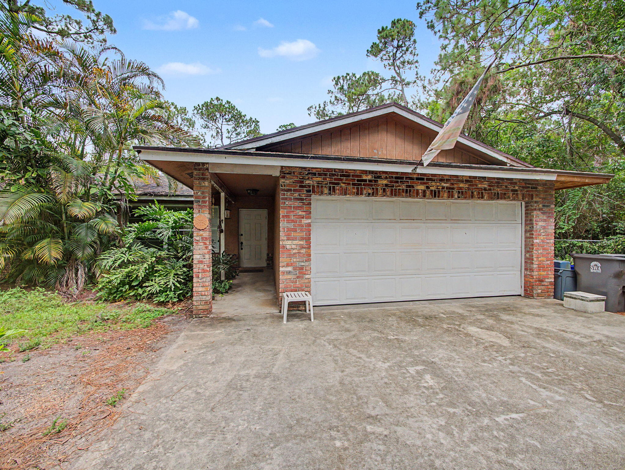 Rare opportunity to own 5 acres in the highly desirable equestrian community of Caloosa in Palm Beach Gardens. This property offers exceptional potential for the buyer looking to renovate, reimagine, or create their ideal estate setting in one of northern Palm Beach County's most unique acreage communities. The existing home is modest in size and in need of updating, but the value is in the land, location, and lifestyle. Caloosa is known for its spacious 5-acre homesites, peaceful setting, and outstanding equestrian amenities. Residents enjoy over 30 miles of interior riding trails, a private 32-acre horse park, dressage arena, riding arena, jump course, cross-country area, pickleball courts, tennis courts, basketball courts, playground, picnic and barbecue areas, community meeting room,  and restrooms. The private park is for the exclusive use of Caloosa residents and their guests. With low HOA dues and a strong sense of community, Caloosa offers a rare combination of space, privacy, and convenience. Enjoy community events, riding activities, and a relaxed country lifestyle while still being just minutes from shopping, dining, top-rated schools, I-95, Florida's Turnpike, The Gardens Mall, Downtown West Palm Beach, and Palm Beach International Airport. Bring your vision and make the most of this 5-acre property in one of Palm Beach Gardens' most sought-after acreage communities.  Features roof: 2005, A/C 2016 approx, water heater 2016, home is fenced with chain link fence, property fenced on 3 sides, septic original and serviced last year, well has softner.  Flat roof 2017. Washer, dryer, dishwasher do not convey.