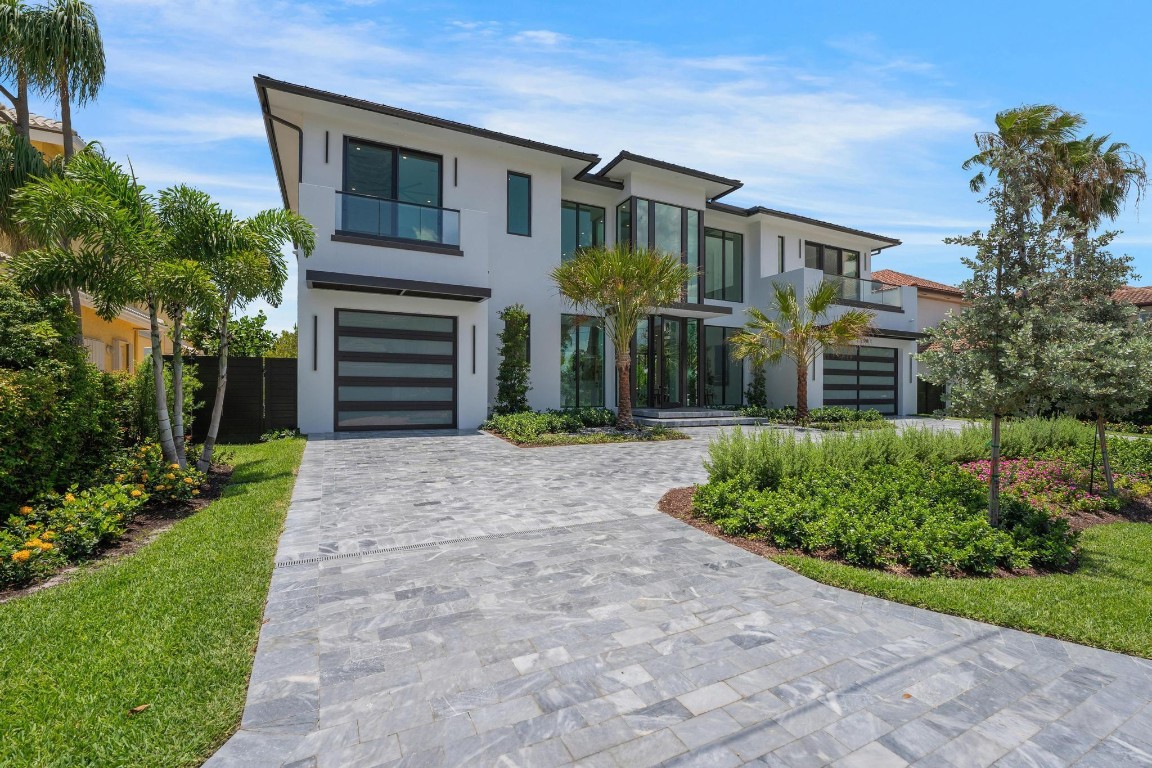 New Construction - 90' of Water frontage - NO Fixed Bridges - Ocean Access - Approx. 5 minutes From Atlantic Ave. This beautiful 7,679 sq. ft entertains 6 en-suite bedrooms, 7.5 baths, 2 primaries. Smart home features Wolf/Sub-Zero appliances, Taj-Mahal with lather finish counter top, Cristallo lit wine room and bar, smart lighting, elevator, wet bar, and marble staircase. Outdoors boasts a saltwater pool, spa, summer kitchen, 47KW generator, Wi-Fi sprinklers, a new seawall and dock with plumbing and electric, power ready for 2 boat lifts. Metal roof, impact windows, and built-in closets throughout. All pre-wired for sound system, shades, sound and video. Move-in ready with top-tier luxury!