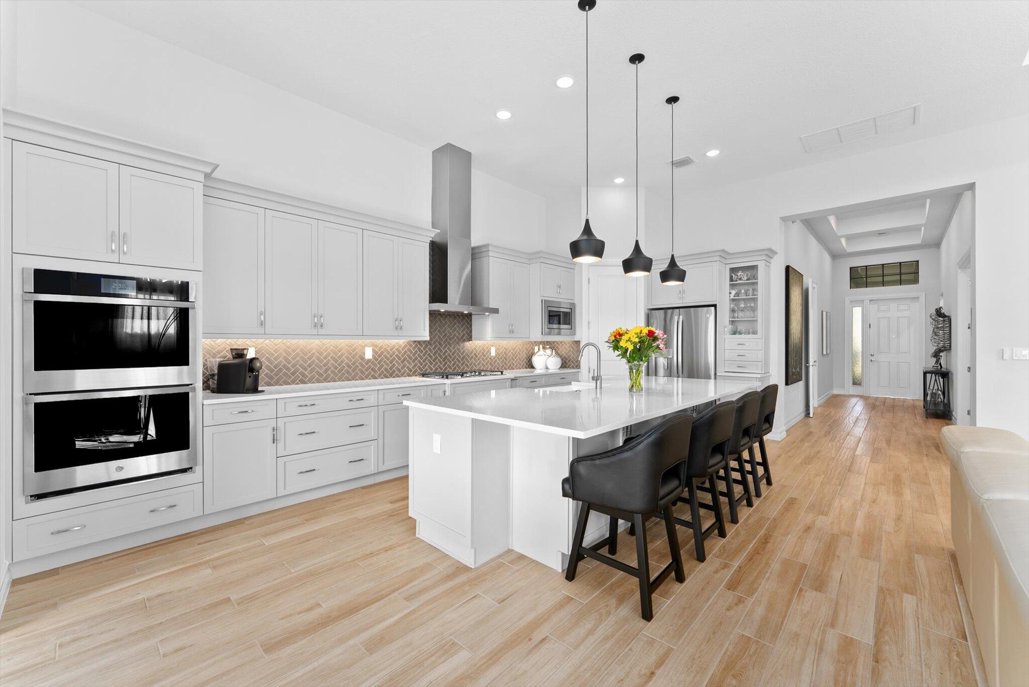 Explore this thoughtfully designed home in like-new condition. Featuring a 2023 Cerelia model with stylish upgrades, it is located in a vibrant 55+ community. Highlights include soaring 13' tray ceilings, porcelain tile flooring throughout, motorized shades, and an open-concept layout filled with natural light from abundant windows and sliders.
The chef's kitchen offers upgraded appliances, ample cabinetry, quartz countertops, an oversized island, and a vented hood. Step out to the lanai with a gas bib ready for your grill, overlooking a fenced yard ideal for pets or visiting grandkids. The spacious garage accommodates two cars plus a golf cart. Enjoy resort-style living with a luxurious clubhouse, fitness center, cafe, tennis and pickleball courts, two pools, game rooms and more, all within a guard gated community.