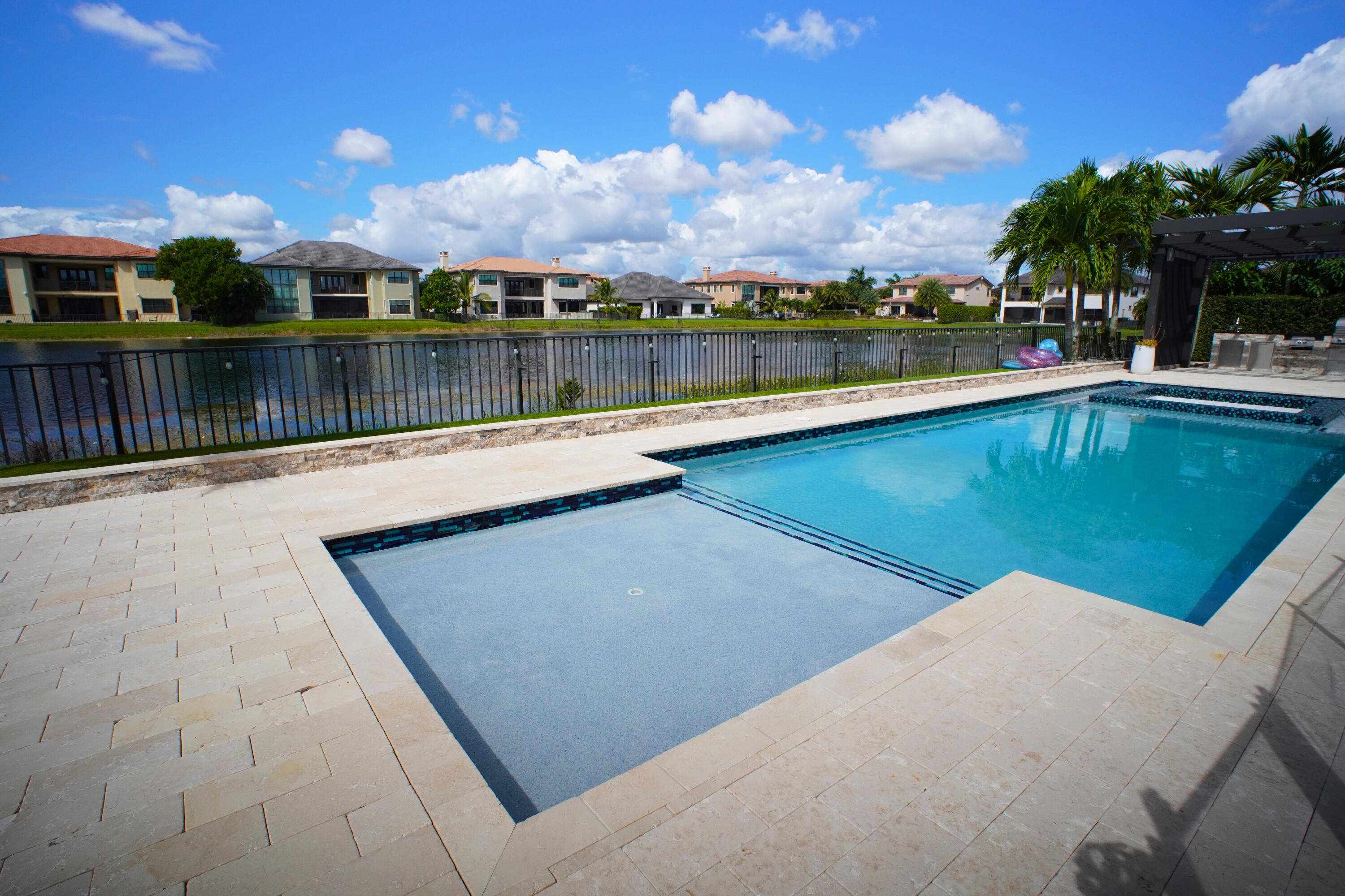 Luxurious 5-bed, 4-bath estate in the prestigious gated community of Watercrest, Parkland. Featuring a private pool, outdoor kitchen, and paid-off solar panels, this home blends elegance with modern efficiency. Enjoy a 3-car garage, open living spaces, and lake views. Community amenities include a state-of-the-art clubhouse, kids' indoor/outdoor play areas, cabanas overlooking the lake, billiards room, and a private bar/lounge for events. Live the resort lifestyle every day in Parkland's most desirable waterfront enclave.  The details don't stop there!    2 premium LIEBHERR stainless steel built-in double refrigerator and freezer units, Fully Built-Out Air-Conditioned Garage Conversion, finished with a one-of-a-kind sliding glass door system, integrated dry sauna, and more ... Seller will remove glass sliders from the garage at the Buyers request. The solar panels on the roof do NOT have an existing lien and are paid off.