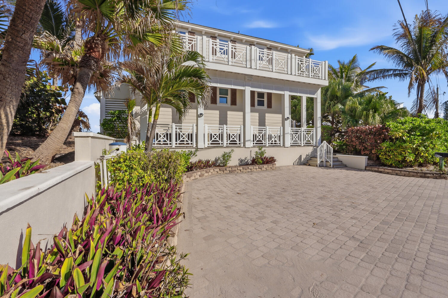 Incredibly rare double-waterfront opportunity! This beautiful home is one of fewer than 60 properties in the USA that borders on both the Atlantic Ocean and the Intracoastal Waterway. Enjoy a sunrise over the ocean, and sunsets over the intracoastal. This breathtaking coastal home offers a large kitchen with Wolf gas range, Sub-Zero refrigerator and two distinct butler's pantries; perfectly poised back deck to listen to the waves; crisp interiors, and absolutely stunning views from every window. Recent updates include gorgeous new deck railings, brand new countertops, and reinforced pilings. Be in the ocean by boat in less than 10 minutes, the 10,000 lb boat lift is ready for your vessel. Walk out your back door to peaceful Bathtub Beach, or dine at popular Sewall's Point restaurants. Impact windows include transferable lifetime warranty. Come see this idyllic waterfront home today. It's the finished beach home you've been waiting for.