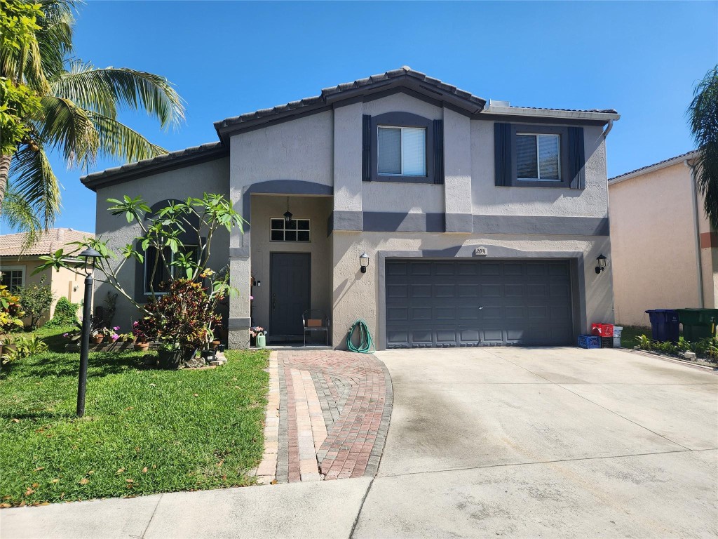 STUNNING HOME FEATURES UPGRADED KITCHEN WITH STAINLESS STEELE APPLIANCES, UPGRADED BATHROOMS, HIGH CELING IN LIVING ROOM & FAMILY OOM, CROWN MOLDING, LAMINATED FLOORS, DOUBLE SINK IN MASTER BATHROOM, ADDITIONAL STORAGE CLOSET & MUCH MORE....IDEAL FOR ENTERTAINING, RELAX & ENJOY LARGE BACK YARD WATER VIEW. LOTS OF FRUIT TREES.  CLOSE TO SHOPS, RESTAURANTS, CHURCHES & FT. LAUDERDALE & MIAMI AIRPORT. DRASTICALLY REDUCED FOR QUICK SALE!