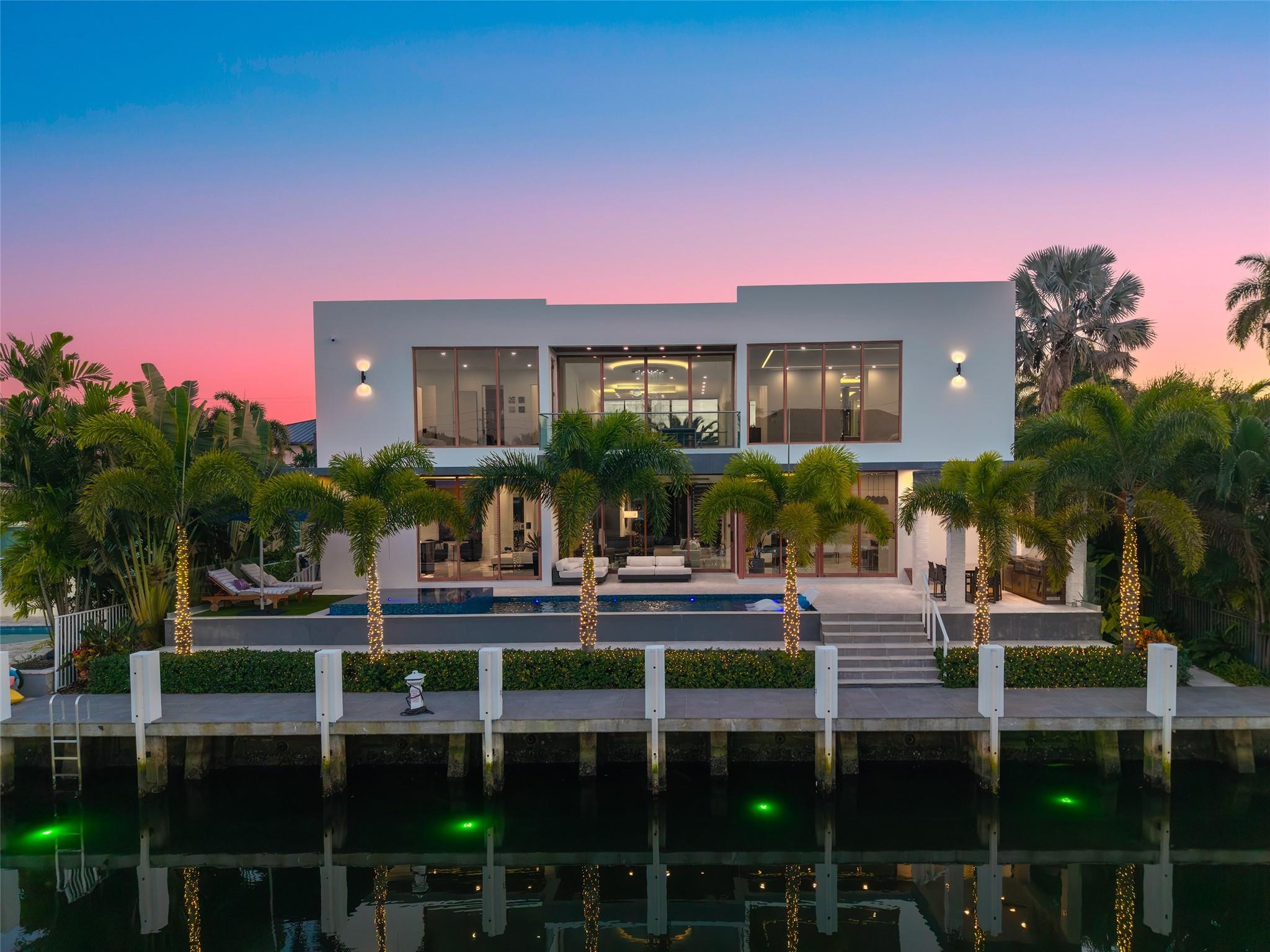 Experience unparalleled modern waterfront luxury in prestigious Lighthouse Point at 2631 NE 48th Ct. This stunning contemporary estate, newly built in 2023, offers nearly 5844 SF under AC, 80' prime deep-water frontage, brand-new private dock, direct Intracoastal-to-ocean access (no fixed bridges). On a serene waterfront street, the 5-bed, 5.5-bath home is designed for seamless entertaining, effortless living, and top security. Highlights: resort-style pool & spa, soaring ceilings, versatile 3-car garage (2+1) with lift-ready high ceilings for up to 6 cars. Advanced smart-home system with voice control manages lighting, shades, locks, audio, TVs, and security. $200k+ in premium upgrades make this exceptional property a bespoke, future-ready waterfront sanctuary including: TOTO Neorest  LS bidets in every bathroom, custom walk in closets in all bedrooms, whole home commercial water filtration and reverse osmosis taps, garage air conditioning, EV charger, Generac generator, mosquito misting system, underwater canal lighting, 4k HDR surveillance system, and enterprise grade wifi & internet. Rarely does a turnkey, ultra-secure waterfront residence in one of Lighthouse Point's most coveted neighborhoods become available—fully equipped for today's luxury lifestyle and tomorrow's innovations. This is more than a home; it's an elevated way of life on the water. Key things to know: Nearly 5844 SF under AC with 80-foot deep-water frontage and private dock; Direct Intracoastal-to-ocean access with no fixed bridges for seamless boating; Resort-style pool and spa flow to indoor spaces with soaring ceilings; Voice control smart-home automation, Lutron automated shades, UniFi 10GB network, and premium upgrades throughout; Three-car garage with lift-ready high ceilings accommodates up to six vehicles.