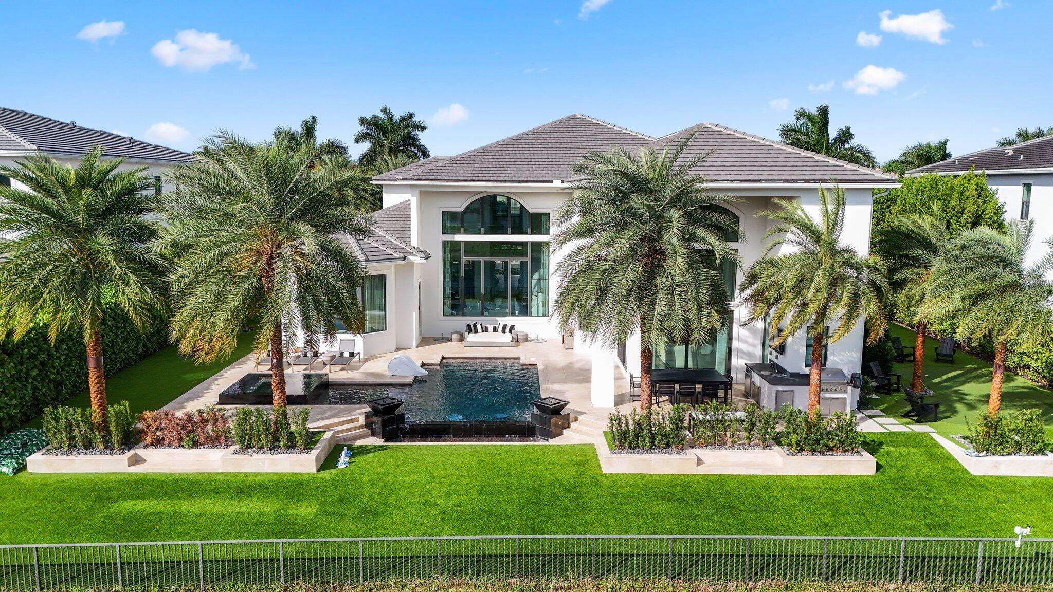Situated on an oversized lake lot in the highly desirable community of Royal Palm Polo. This rare Casa Allegre model is an impressive two-story residence w/ sophisticated design. Each curated space is masterfully designed for luxurious living & entertaining. This custom home boasts 5,757 living SF, 5 bedrooms, 5.3 bathrooms, office, theater & loft. Gourmet open kitchen with breakfast nook overlooking  your dream backyard. All bedrooms have ensuite baths.  Through the sliding glass doors, enjoy your private outdoor space that features a custom pool, spa, sunshelf, fire features an outdoor kitchen, XL rear and side yards with putting green and playground for the kids. Full House generator.  Royal Palm Polo is a gated - non membership gated community with amenities! See Floorplan in photos.