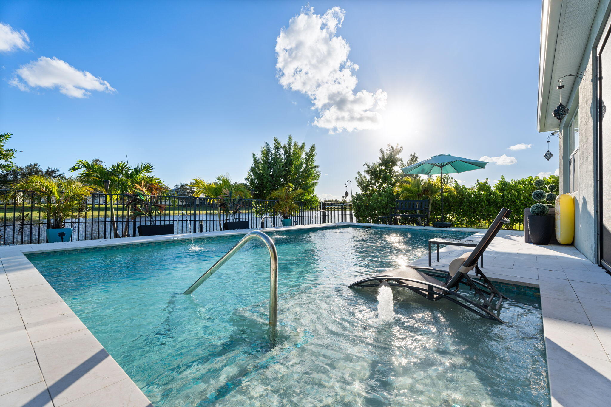 Priced to sell — and it won't last. This upgraded lakeview home in Emery at Tradition features a heated saltwater pool with sun shelf, in-water seating, and spa jets, all backing to a serene private lake. Inside enjoy an open floor plan with vaulted ceilings, ceramic tile throughout, and impact glass windows. Flexible living spaces, abundant natural light, and quality finishes throughout. Resort-style community amenities, parks, walking trails, top-rated schools, dining, and Tradition Square all nearby. Best value in Tradition at this price point — schedule your showing before someone else does.