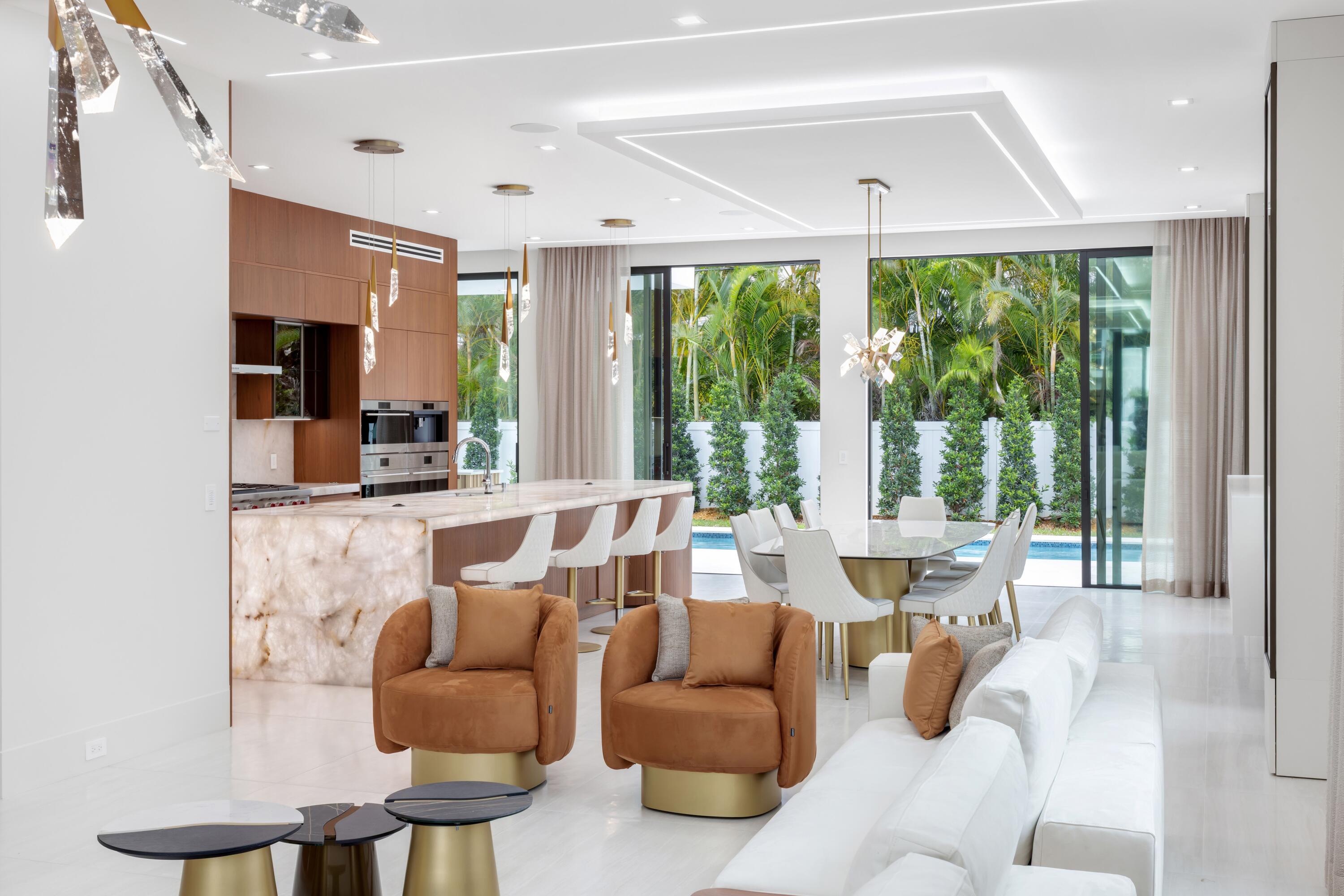 In the prestigious "Golden Triangle," a premier crown-jewel district in the heart of Downtown Boca Raton, this brand-new, fully furnished contemporary residence, developed by Yacov Development Group, epitomizes elegant Florida living on a grand scale. Soaring ceiling heights, rich paneled detailing, custom built-in cabinetry, electric window treatments, handsome hardwood and Italian flooring. The designer lighting and window-walls of glass offering serene pool and manicured-landscaped garden views and are among the many fine appointments found throughout. With five bedrooms, six-and-a-half bathrooms and 5,969± square feet of living space, this exceptional residence is introduced by an impressive two-story foyer with a floating glass-and-metal stairway that extends to the great room, with living and dining areas. In an open-concept plan, the adjacent chef's kitchen is beautifully fitted in wood and quartzite with stainless-steel Wolf, Cove and SubZero appliances. On the second level, the primary suite is an oasis of tranquility, with a spa-inspired bathroom finished in quartzite and custom-fitted wardrobe closets. On the top level, an 839± square-foot clubroom/lounge opens to a covered terrace with an outdoor kitchen flowing to a rooftop skydeck overlooking cityscape vistas. Completing the layout are two bars, an elevator, two laundry rooms, cabana bathroom and a three-car garage, with the capability to accommodate car lifts, along with additional conveniences including Control4 smart home technology and four air-conditioning units. DISCLAIMER: Information published or otherwise provided by the listing company and its representatives including but not limited to prices, measurements, square footages, lot sizes, calculations, statistics, and videos are deemed reliable but are not guaranteed and are subject to errors, omissions or changes without notice. All such information should be independently verified by any prospective purchaser or seller. Parties should perform their own due diligence to verify such information prior to a sale or listing. Listing company expressly disclaims any warranty or representation regarding such information. Prices published are either list price, sold price, and/or last asking price. The listing company participates in the Multiple Listing Service and IDX. The properties published as listed and sold are not necessarily exclusive to listing company and may be listed or have sold with other members of the Multiple Listing Service. Transactions where listing company represented both buyers and sellers are calculated as two sales. "No payments made until title passes" Some affiliations may not be applicable to certain geographic areas. If your property is currently listed with another broker, please disregard any solicitation for services. Information published or otherwise provided by seller, listing company or its representatives is deemed reliable but are not guaranteed and subject to errors, omissions, or changes without notice. Copyright 2026 by the listing company. All Rights Reserved.