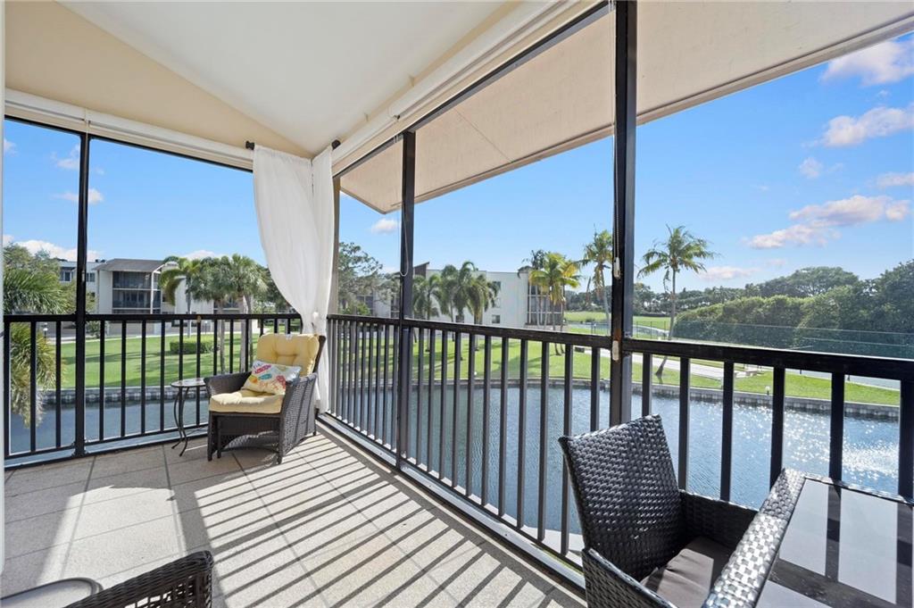Come see this completely updated 2/2 Lakefront corner Condo. Beautifully remodeled upgraded open kitchen with new cabinets, new appliances, Corian countertops, and wood floors, you'll love to entertain your guests here. Move right in as sold furnished.  Unit has a huge wrap-around screened balcony offering plenty of light and serene water & golf views. Master bath has a whirlpool jet tub to relax after a long day. Updated baths, new blinds & cabana shades, new carpets, extra storage and deeded Covered Parking. Longwood offers a heated pool, clubhouse, fitness & tennis courts. Close to all the shopping and casual & fine restaurants along PGA Blvd. Close to lovely beaches. Love how you live in this 55+ Community. Can install your own stackable  washer/dryer. SECOND FLOOR WITH NO ELEVATOR.