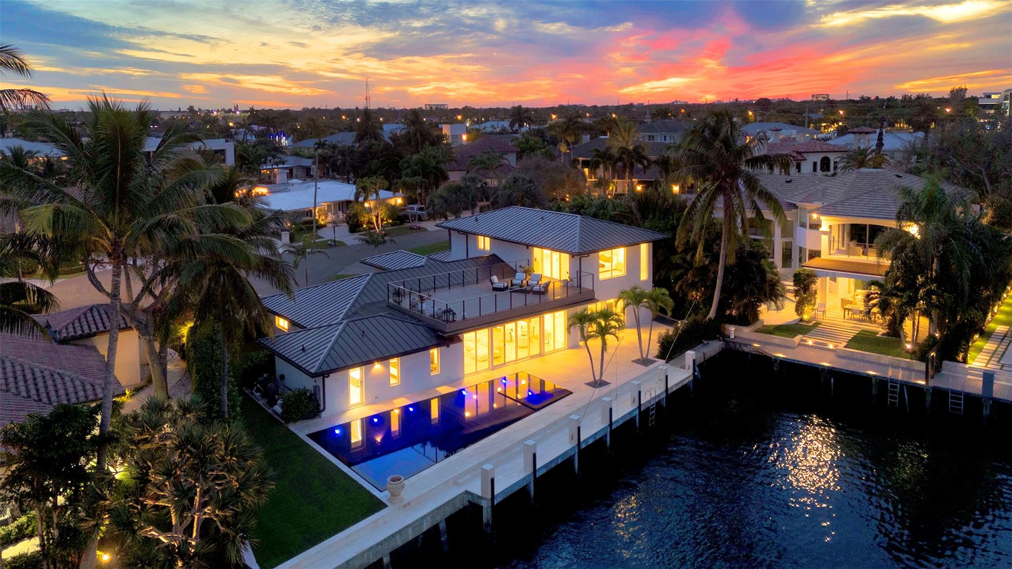 Welcome to this stunning, fully renovated waterfront home in the Lake Rogers neighborhood of Boca Raton. Boasting over 115' of dock space, this property is perfect for boating enthusiasts!Step inside to discover a meticulously designed interior featuring a custom kitchen with high-end finishes, bespoke cabinetry, and an open-concept layout that seamlessly blends style and functionality. Sunlight pours into every room, highlighting breathtaking water views from every angle. Outdoors, indulge in your private oasis with a custom-designed pool just steps from the Intracoastal. Perfect for entertaining or relaxing, the spacious patio offers a seamless indoor-outdoor flow.  Offering a short 5 minute walk to the beach, this home is a masterpiece of design and location! Indulge in the finest features: • Private deep-water dock, ideal for yachts and leisurely sunset cruises • Meticulously manicured grounds, offering the potential for a resort-style pool and outdoor entertainment spaces • Grand interiors with soaring ceilings, custom finishes, and seamless indoor-outdoor transitionsLocated just moments from Boca Raton’s world-renowned dining, upscale boutiques, and pristine beaches, this estate is more than a home—it’s a lifestyle. Experience the epitome of waterfront luxury at this extraordinary address.
