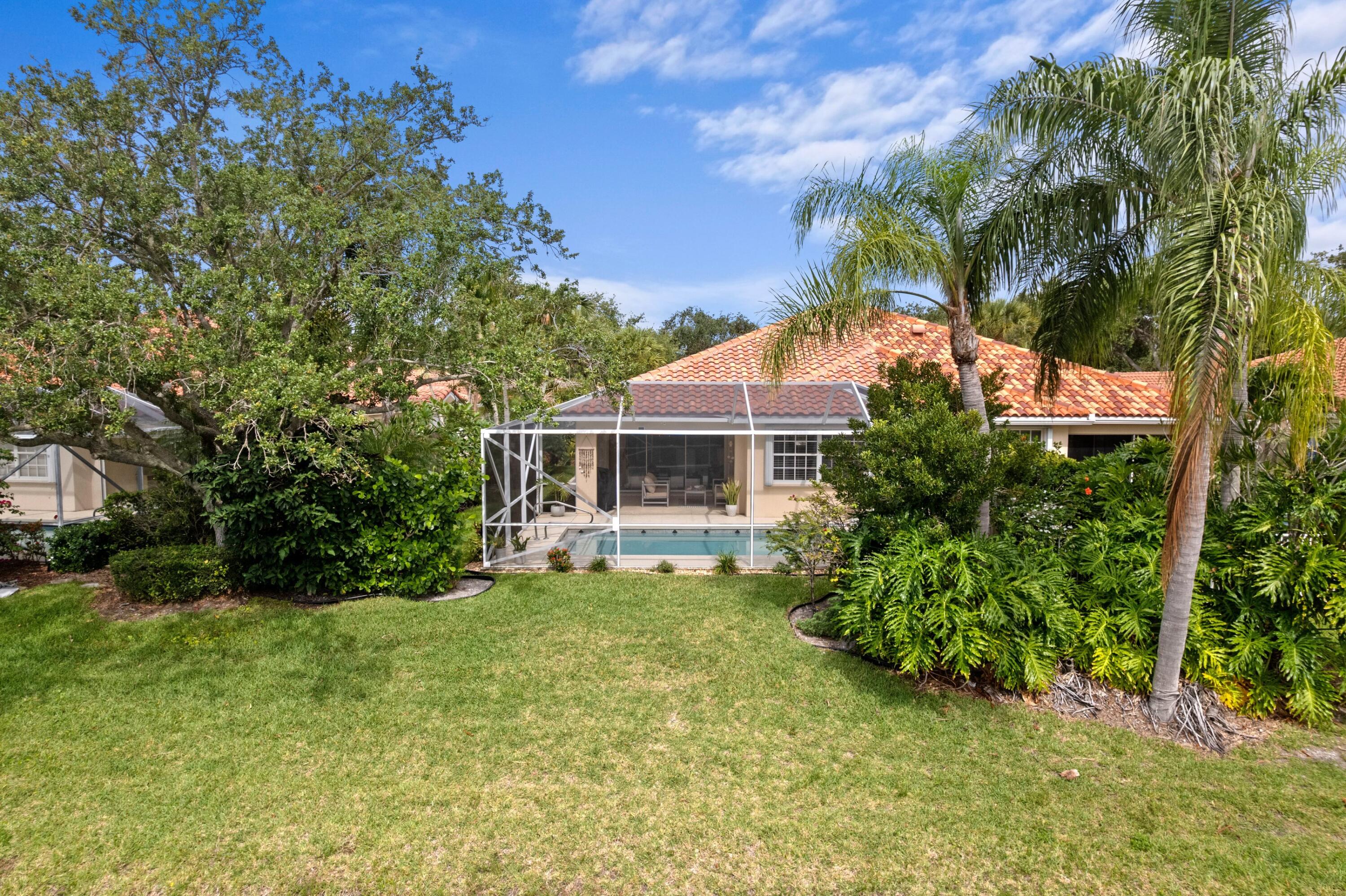Stunning, completely renovated lakefront estate in the highly desired Riverwalk community.  Step inside to discover a masterpiece of modern design, featuring custom floor-to-ceiling built-ins, bespoke window treatments, and high-end finishes throughout. The chef's kitchen is a standout, boasting custom cabinetry, granite countertops, and a classic farmhouse sink. Retreat to the luxurious primary suite, complete with a custom master closet and beautifully tailored vanities.  Outside, your private tropical paradise awaits. Relax by the pristine, refinished pool, surrounded by lush landscaping and a newly rescreened/painted enclosure (2024). Peace of mind comes standard with a new roof and gutters (2024), a brand-new washer/dryer (2026), full hurricane accordion shutters, and a 2-car garage with immaculate epoxy flooring.  Riverwalk offers resort-style living with low HOA fees. Enjoy an unmatched amenity package: 3 heated pools, a fitness center, pickleball, Har-Tru tennis courts, bocce, a playground, 12 miles of scenic trails, a beauty salon, and a full-service restaurant (complete with a $120 annual food credit!). The comprehensive HOA also includes cable, high-speed internet, lawn maintenance, exterior pest control, manned gated security, and exterior house painting every 5-7 years. Surrounded by a quiet nature preserve, this home offers the perfect blend of luxury, community, and tranquility.