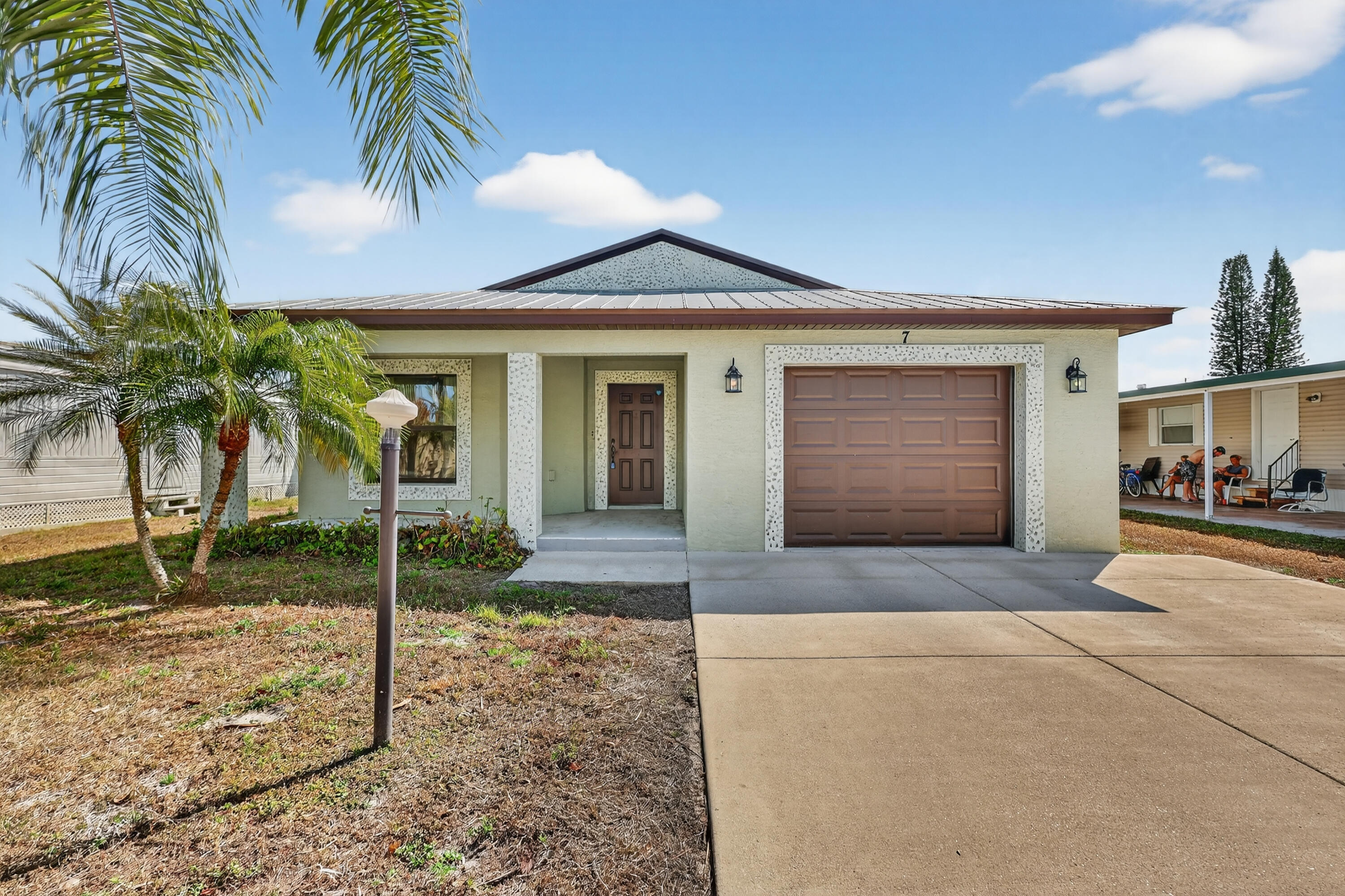 Find ELEGANCE, DURABILITY, SAFETY & AFFORDABILITY in this 2018 2bed/2bath home. Nestled in a quiet 55+community this home is BUILT to LAST. Only 1 owner w/ this gem! The solid Concrete Block Construction w/ a Metal Roof built over Plywood offers max strength. Key Pad Entry, Open Concept, Vaulted Ceilings,LED Recessed Lights, Large rooms, GRANITE Countertops, Stainless Steel Appl. Master suite boasts walk-in closet & en-suite bathroom w/ dual sinks. LARGE PATIO. PRIME LOCATION; near the beach (BUT NOT IN A  FLOOD ZONE), shopping, mall, grocery, restaurants, bank,hospital,postal & more! Lot lease 628.90 includes trash, lawn care, Clubhouse w/Activities, Private FREE Golf Course,Heated Pool,Spa,Fitness,Pickleball,Tennis, Shuffleboard Bocce,Library, Bingo, Parades, MahJong,Workshop & more!