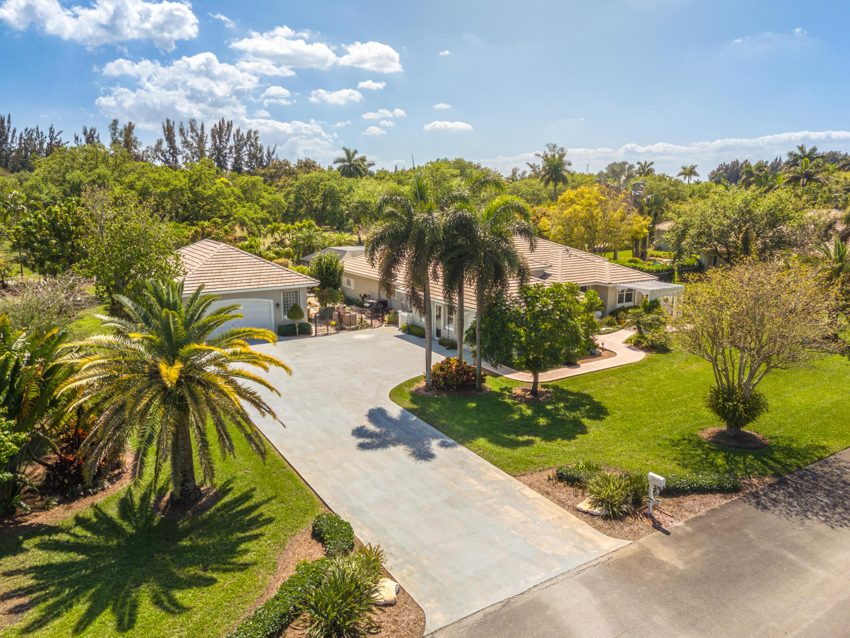 Welcome to this exceptional Davie home on a lush builder's acre! The property features a 4-bedroom, 3-bath main residence plus a detached garage/workshop with a beautifully renovated private studio apartment ideal for guests, in-laws, or a home office. Major upgrades include a new roof (2024), AC (2025) with warranty through 2035, water heater (2026), pool resurfaced in 2022 with a 10 year warranty, and more! A whole-house generator ensures year-round comfort! Inside offers high ceilings, a desirable triple-split floor plan, and a large converted 2-car garage in the main house perfect for a theater, game room, or flex space. Located in a gated community with low HOA fees this property offers space, flexibility, and long-term value right in the heart of Davie *Seller offering $25,000 credit