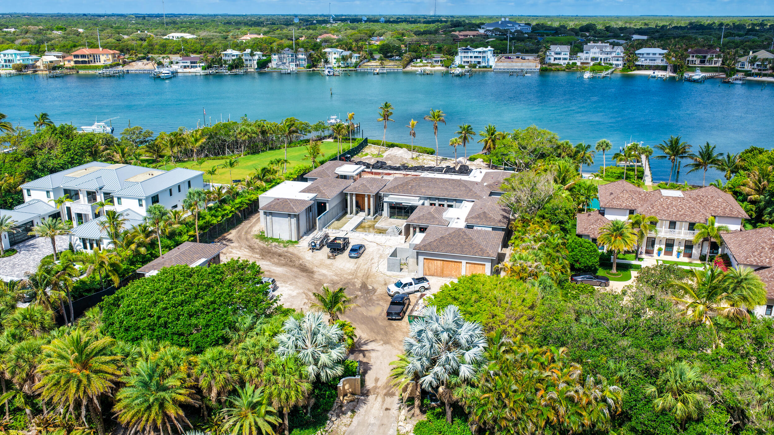 Set on over 1.6 acres on the desirable south end of Jupiter Island, this exceptional waterfront estate is being masterfully built by award-winning Turtle Beach Construction. The property offers phenomenal wide water Intracoastal views and direct ocean access with no fixed bridges. Perfectly positioned to offer both privacy and convenience, it is just moments from the restaurants, golf, and amenities of Jupiter and Tequesta while still capturing the natural beauty and exclusivity that define Jupiter Island.  Planned as a fully integrated waterfront compound, 508 South Beach Road is composed of three distinct yet cohesive structures: a sprawling one-story main residence, a detached guest house, and a separate office and gym pavilion. The layout has been thoughtfully designed to create a true resort-style experience, with the main residence and primary living areas oriented toward the water and connected through expansive outdoor spaces.  At the center of the property, a resort-style pool anchors the estate, creating a strong visual and functional connection between the main residence, guest house, and pavilion. Clean architectural lines, integrated lounging areas, and expansive terraces combine with layered tropical landscaping to create a setting that is both visually striking and highly functional, designed for both entertaining and everyday use.  A gated motor court provides a strong sense of arrival, leading into a residence oriented toward amazing Intracoastal views. The outdoor spaces extend naturally to the waterfront, where a private dock completes the offering and enhances the property's boating lifestyle.  508 South Beach Road represents a rare opportunity to secure a newly constructed, design-forward waterfront compound on one of Jupiter Island's most sought-after stretches, where scale, layout, and setting come together to create a truly exceptional coastal estate.