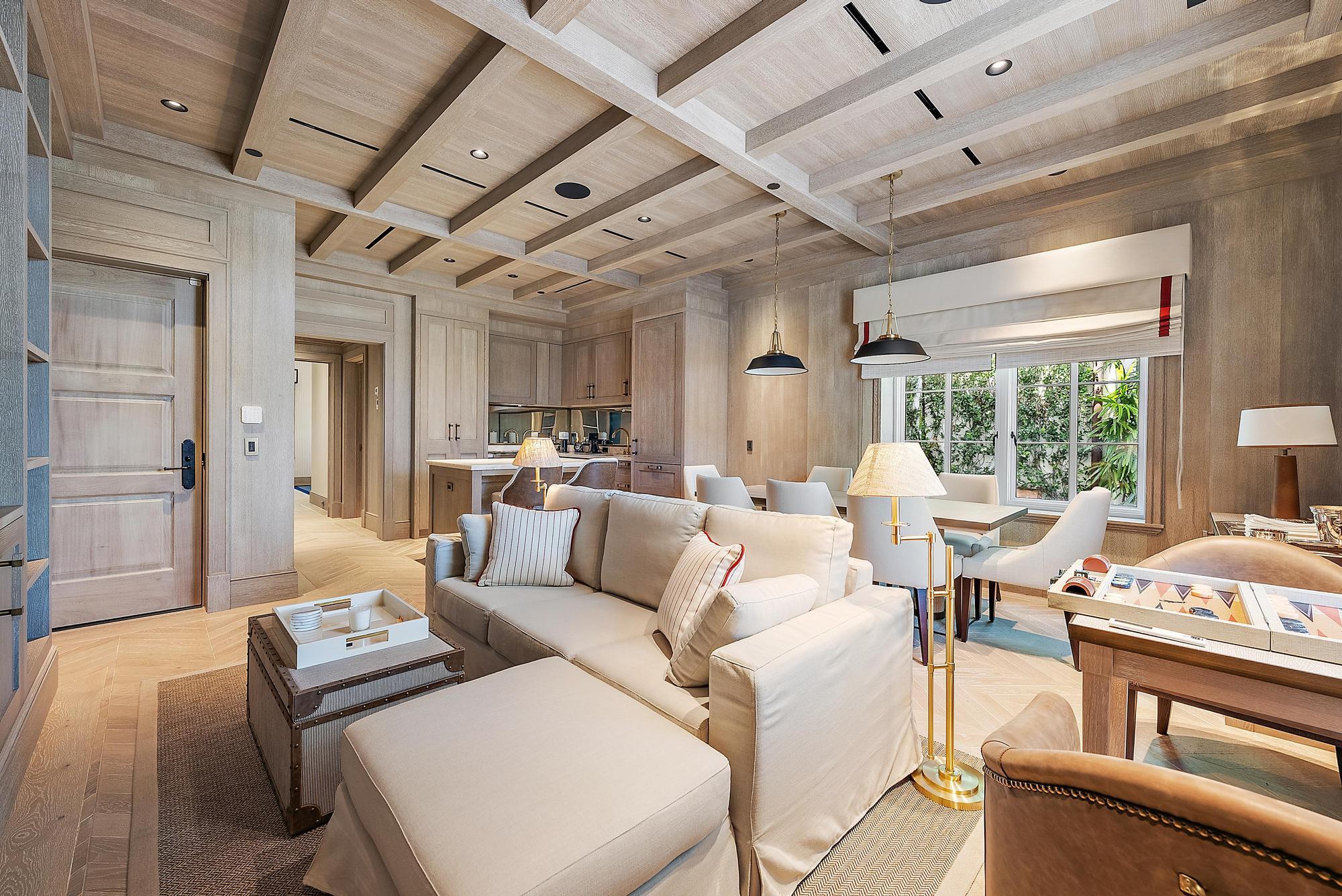 Live the Palm Beach lifestyle in this fully furnished, designer one-bedroom residence defined by impeccable craftsmanship and bespoke interiors. Thoughtfully curated with rich oak paneling, herringbone wood floors, and custom millwork throughout--including built-in closets, bookshelves, and tailored kitchen and bath cabinetry--the home is a true statement of timeless design. Loro Piana upholstered fabric walls, playful designer wallpapers, and warm brass accents create a layered, sophisticated aesthetic that feels both elevated and inviting.

The chef's kitchen is appointed with a Sub-Zero 30'' refrigerator, Wolf dual range hooded cooktop and gas oven, and Wolf 24'' microwave, seamlessly blending performance and style. The bath offers a spa-like escape with a seamless marble steam shower Live the Palm Beach lifestyle in this fully furnished, designer one-bedroom residence defined by impeccable craftsmanship and bespoke interiors. Thoughtfully curated with rich oak paneling, herringbone wood floors, and custom millwork throughout--including built-in closets, bookshelves, and tailored kitchen and bath cabinetry--the home is a true statement of timeless design. Loro Piana upholstered fabric walls, playful designer wallpapers, and warm brass accents create a layered, sophisticated aesthetic that feels both elevated and inviting.

The chef's kitchen is appointed with a Sub-Zero 30" refrigerator, Wolf dual range hooded cooktop and gas oven, and Wolf 24" microwave, seamlessly blending performance and style. The bath offers a spa-like escape with a seamless marble steam shower and Toto auto-flush fixtures. Modern conveniences such as a Maytag stacked washer/dryer, Sonos home sound system, and Lutron smart lighting provide effortless comfort and control.

Intimate in scale yet grand in detail, this turnkey Palm Beach retreat delivers luxury, character, and refined living--ideal as a chic seasonal escape or an elegant year-round residence.