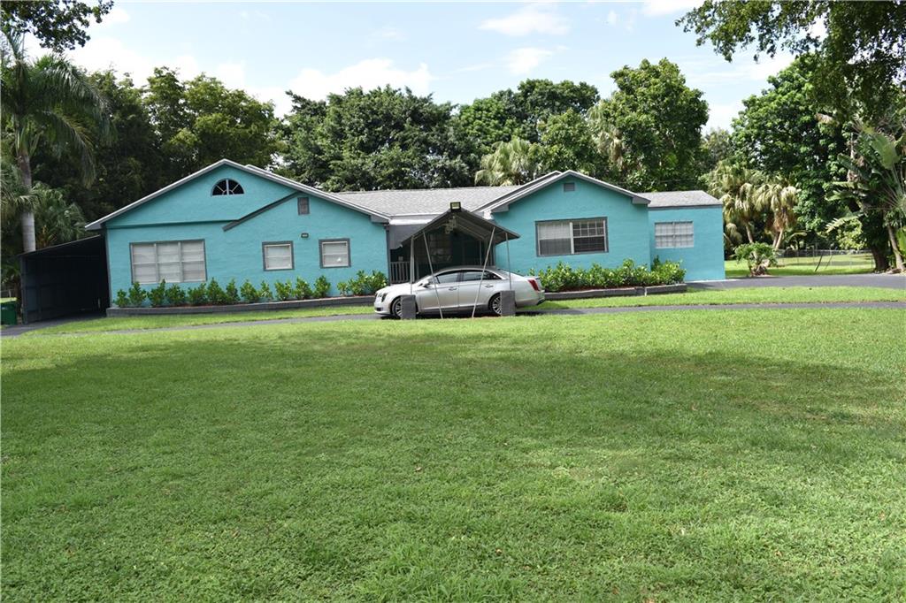 OWNER WILL FINANCE THE SALE OF THIS PROPERTY NO BANK NEEDED ::   Approximately 4000 sq. foot under air. Home has been redone top to bottom. New Floors, Kitchen, Appliances light fixtures and ceiling fans. Has hurricane  shutters and hurricane straps to get better price on Insurance. 4 Large bedrooms, 3 full baths, two large patios and a approx. 500 sq. foot building used as a art studio  This has also been redone inside and out. Lot is just under 1.5 acres and backs up to lake Okeechobee.  Drive under canopy to the front door so you don't get wet when it rains and carport on the side of the home has an entrance to the home also. 2 zones of central air in the house plus a wall unit in the studio unit. Beautiful landscaped beds with  mulch in the beds and and the yard is stunning and open.