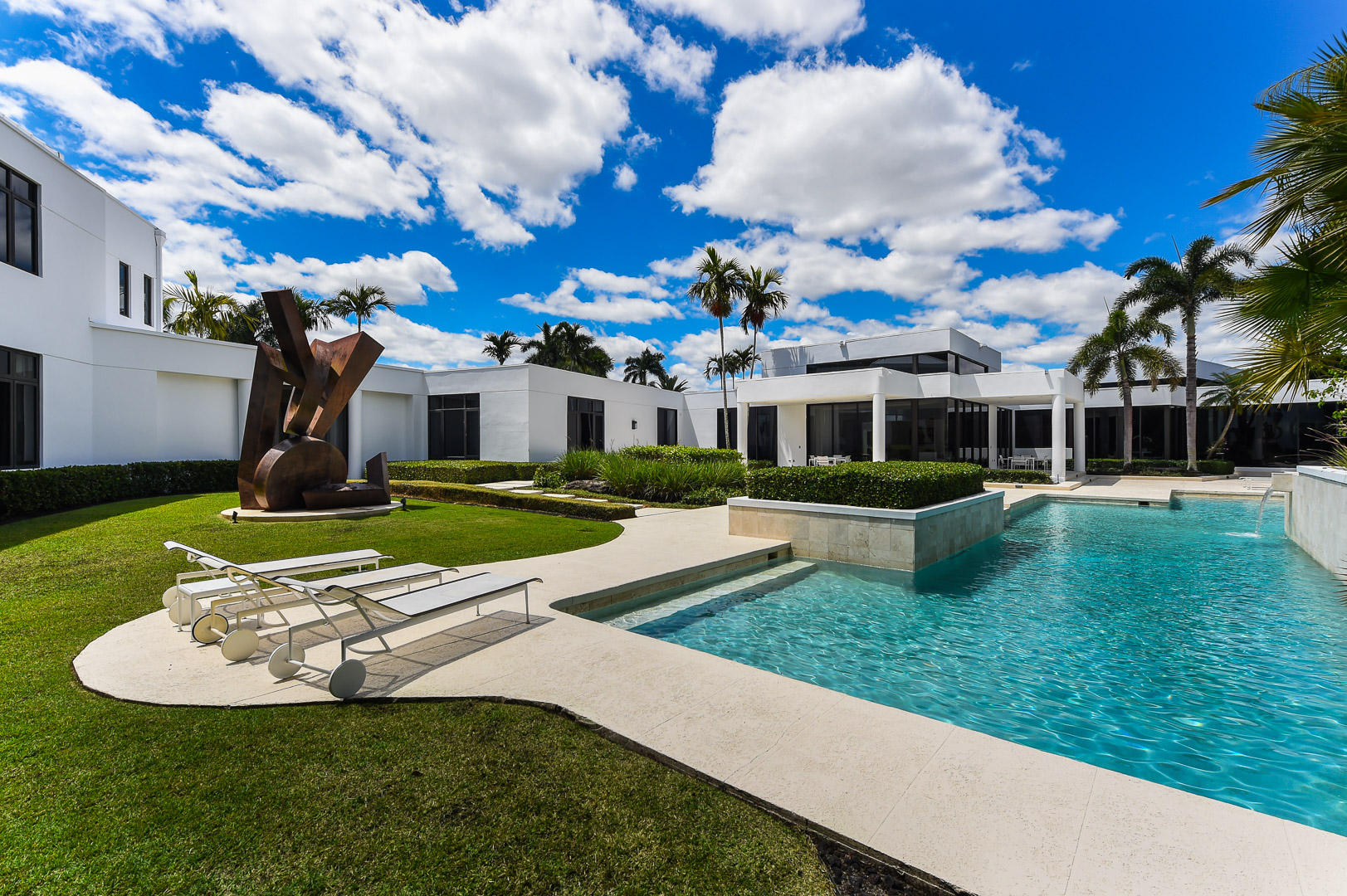 For a Buyer who enjoys a very fine lifestyle!  Exquisite architectural detail and design. Nothing will compare at this pricing.Words will not describe the elegant details of this one-of-a-kind estate. I promise you will not be disappointed.  St. Andrews & Pinecrest private schools a 5 minute drive. Take advantage of this opportunity to purchase a spectacular  Custom Contemporary home in the prestigious Boca Grove, sitting on a private lushly-landscaped one-acre lot on a cul de sac street, this Art Collectors dream home is 11,547 air conditioned square feet, has 6 bedrooms, 9 full & 2 half baths, maid's quarters, a 75 x 30 ft  designer pool, a separate guest house, and a 5 car garage w/ an oversized circular drive. Renovated and new addition in 2004. Please mark this as a ''must see''!
